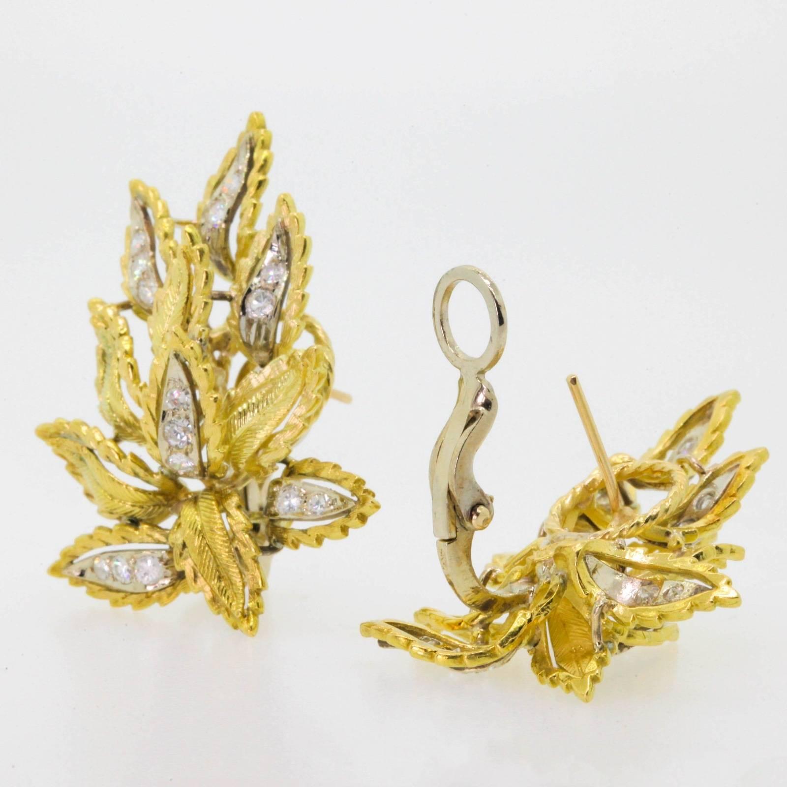 These stylish 18KT yellow gold earrings are designed as a fluid cluster of leaves accented with shimmery 1.00 carat of Round Brilliant Cut Diamonds set in 18KT white gold.  The earrings are set with straight post and omega backs.  Circa 1970s.  The