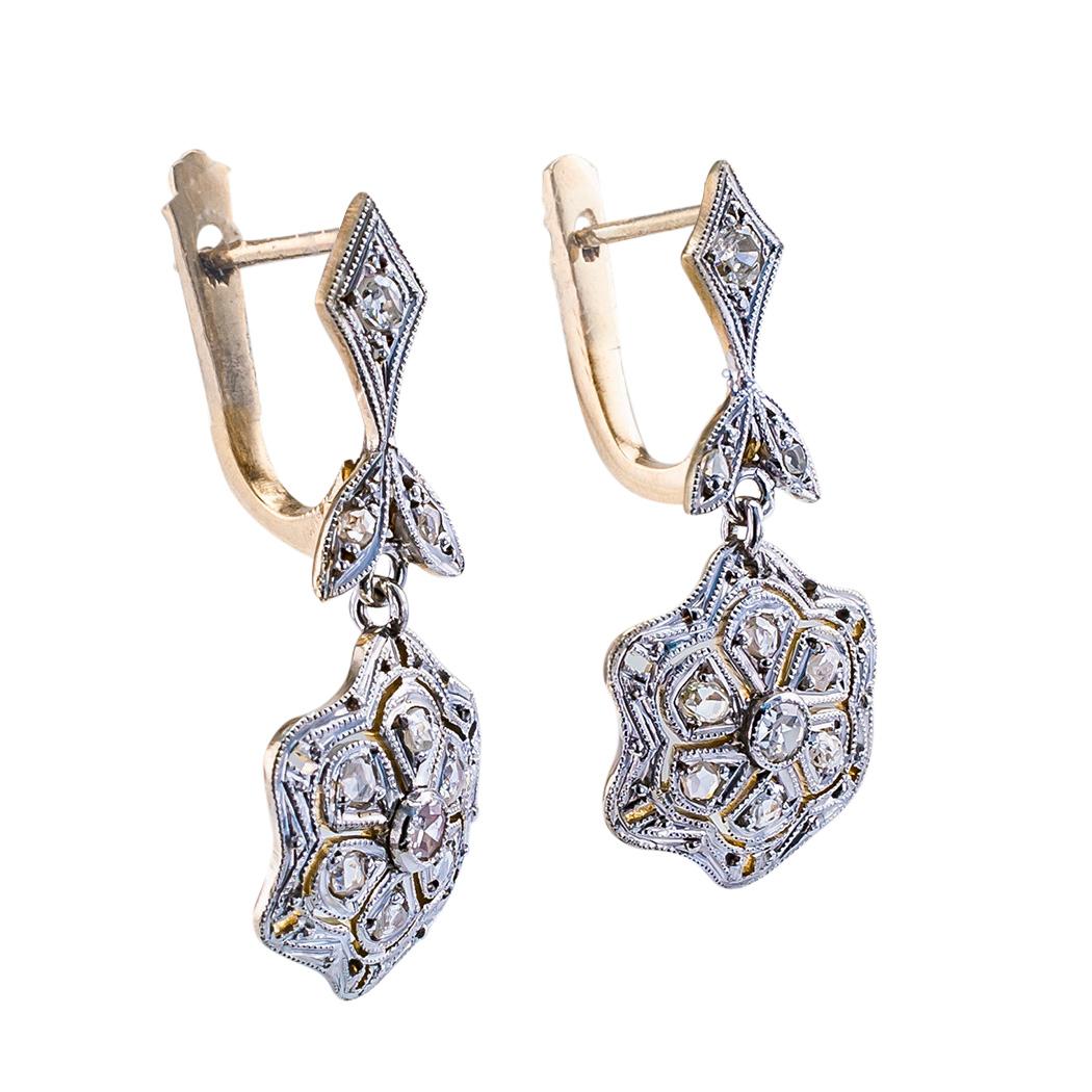 Vintage diamond gold and platinum drop earrings circa 1930.

DETAILS:

DIAMONDS:  twenty rose cut and old-cut diamonds totaling approximately 0.30 carat.

METAL:  14-karat yellow gold and platinum

EARRING BACKS:  hinged supports with