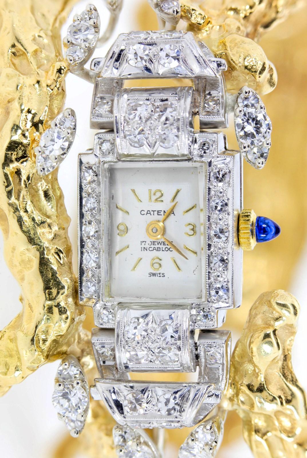 This distinctive beauty has been cherished since the 1960s.  It incorporates a 14KT white gold Swiss made watch in a free form hand wrought 18KT yellow gold branch like bangle.  Diamond Marquise sections float above and below the watch.  The medley