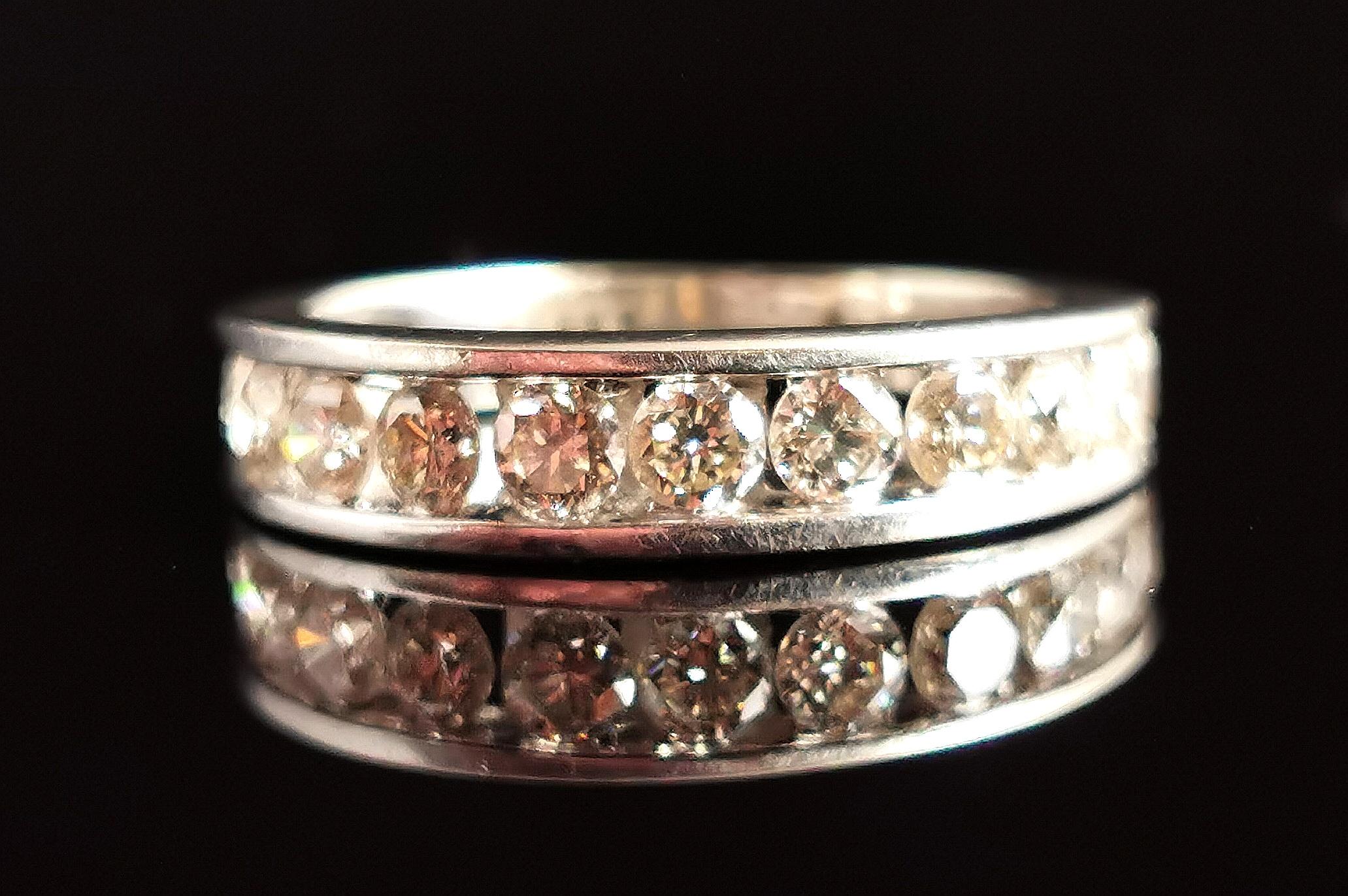 A gorgeous vintage Diamond half hoop eternity ring.

Stacked full of sparkling white brilliant cut diamonds, channel set into the front half of the ring, all open backed letting the light glisten through.

It has a chunky 9ct white gold setting and