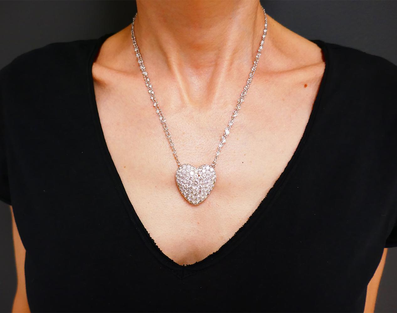 A feminine diamond Heart 14k gold necklace. Comprised of a diamond heart-shaped pendant and a diamond by the yard chain necklace.
The heart pendant features pave set diamonds in a white gold frame. Diamonds’ size graduate from the center to the