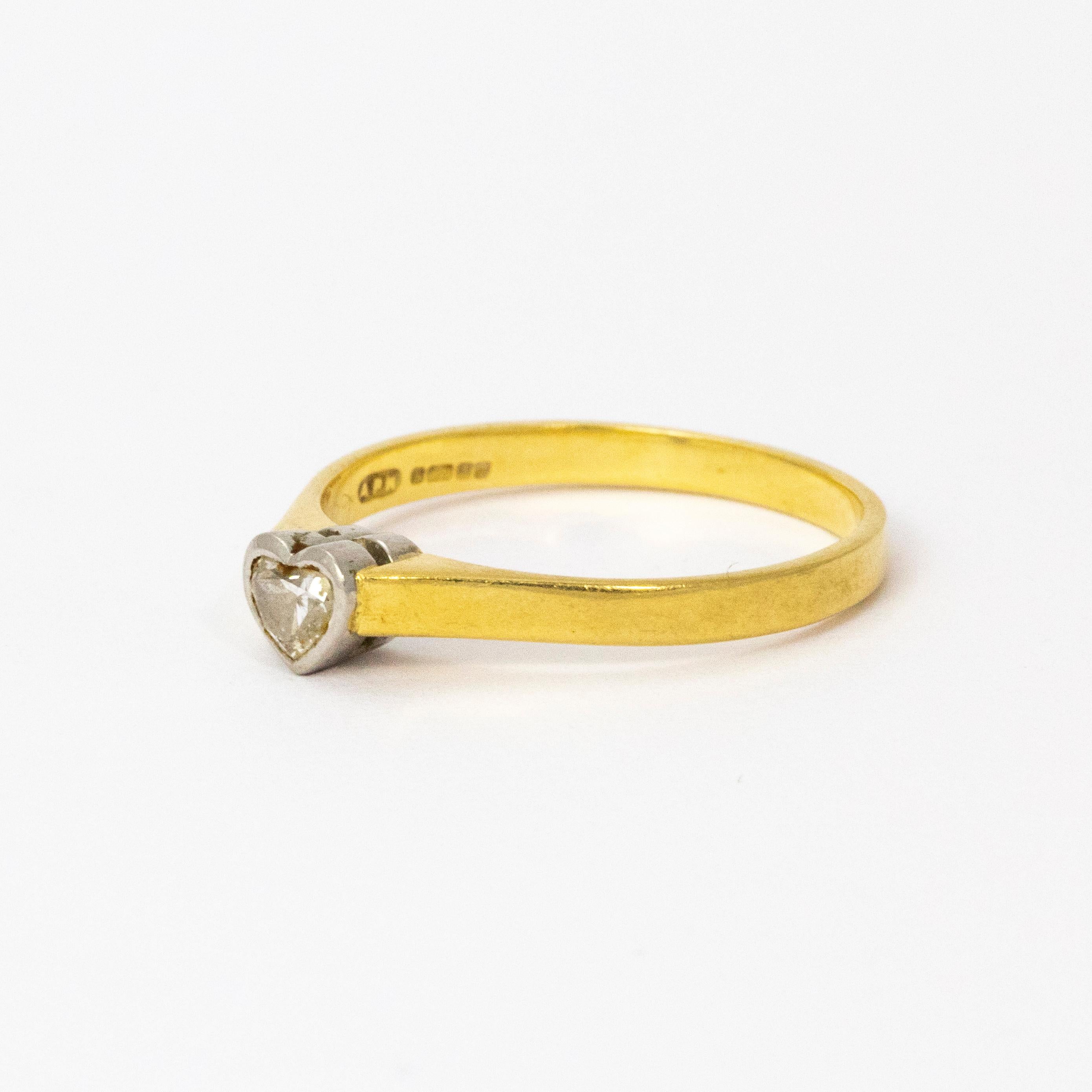 A wonderful vintage ring featuring an incredible central heart-shaped diamond in a complementing platinum heart setting. Band modelled in 18 karat yellow gold.

Ring Size: R 1/2 or 9