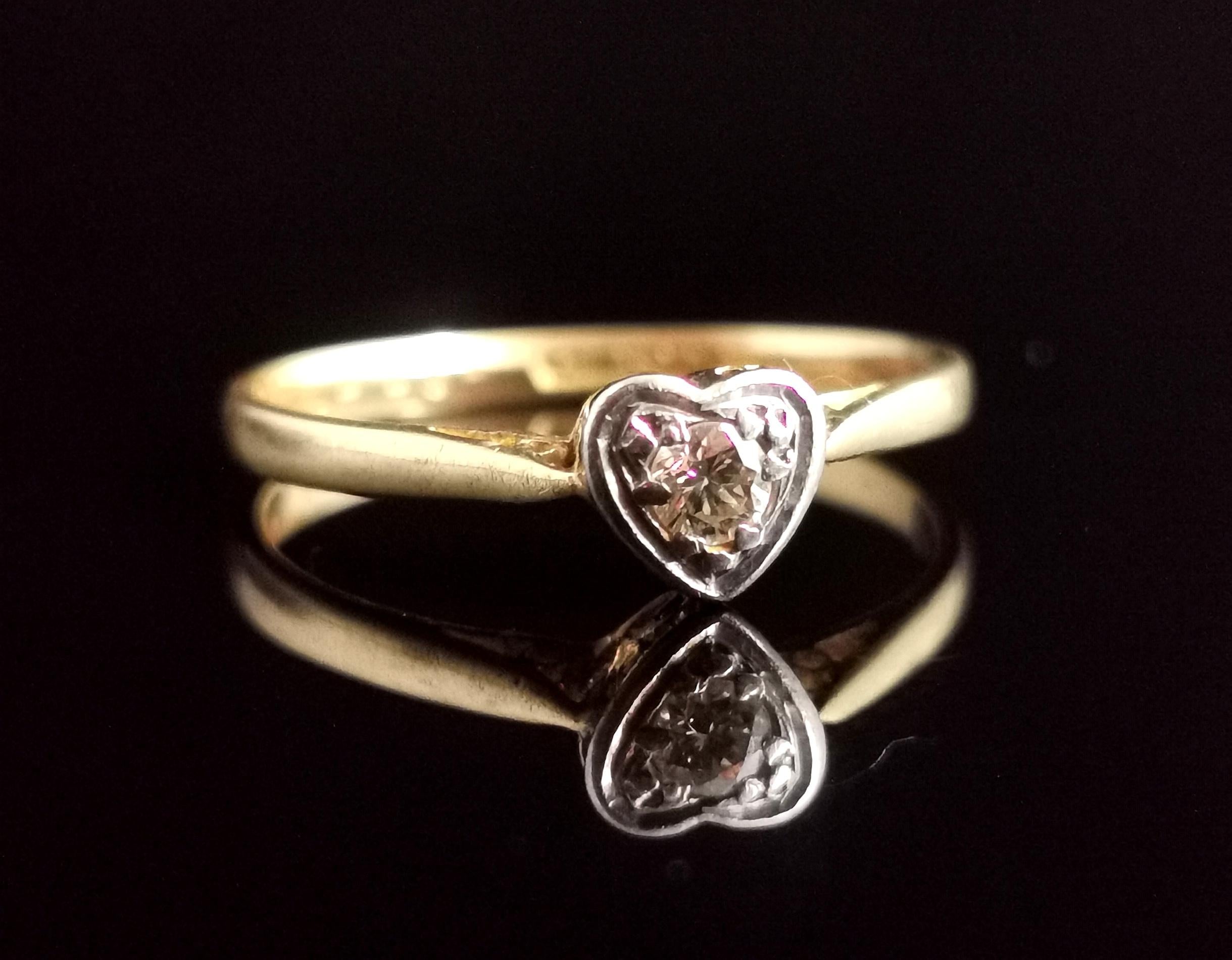A pretty and romantic vintage Diamond heart ring.

Crafted from rich 18kt yellow gold, Diamond and platinum in an Art Deco style.

It has a rich 18kt yellow gold band leading up to the front platinum setting, it is designed as a heart with the