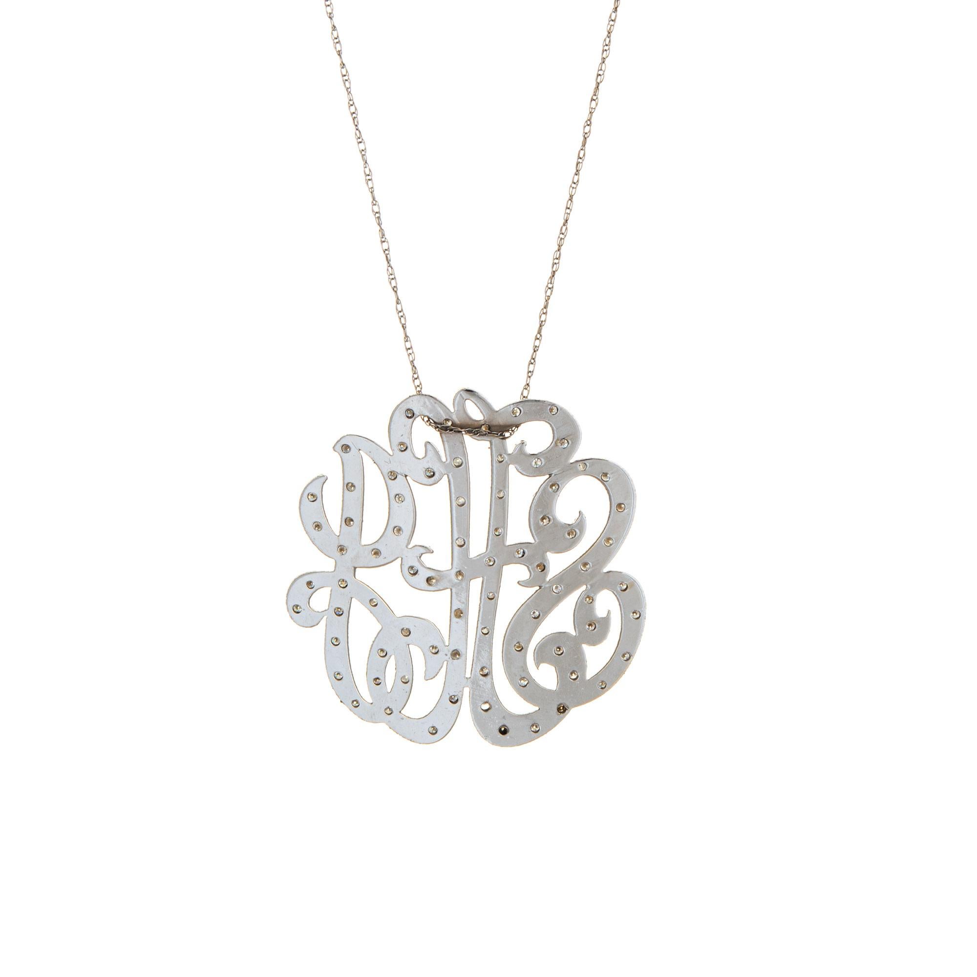 Finely detailed vintage initial pendant crafted in 14k white gold (circa 1950s to 1960s).  

Diamonds total an estimated 0.38 carats (estimated at I-J color and SI2-I2 clarity). 

The charming pendant features cursive script with the initials 