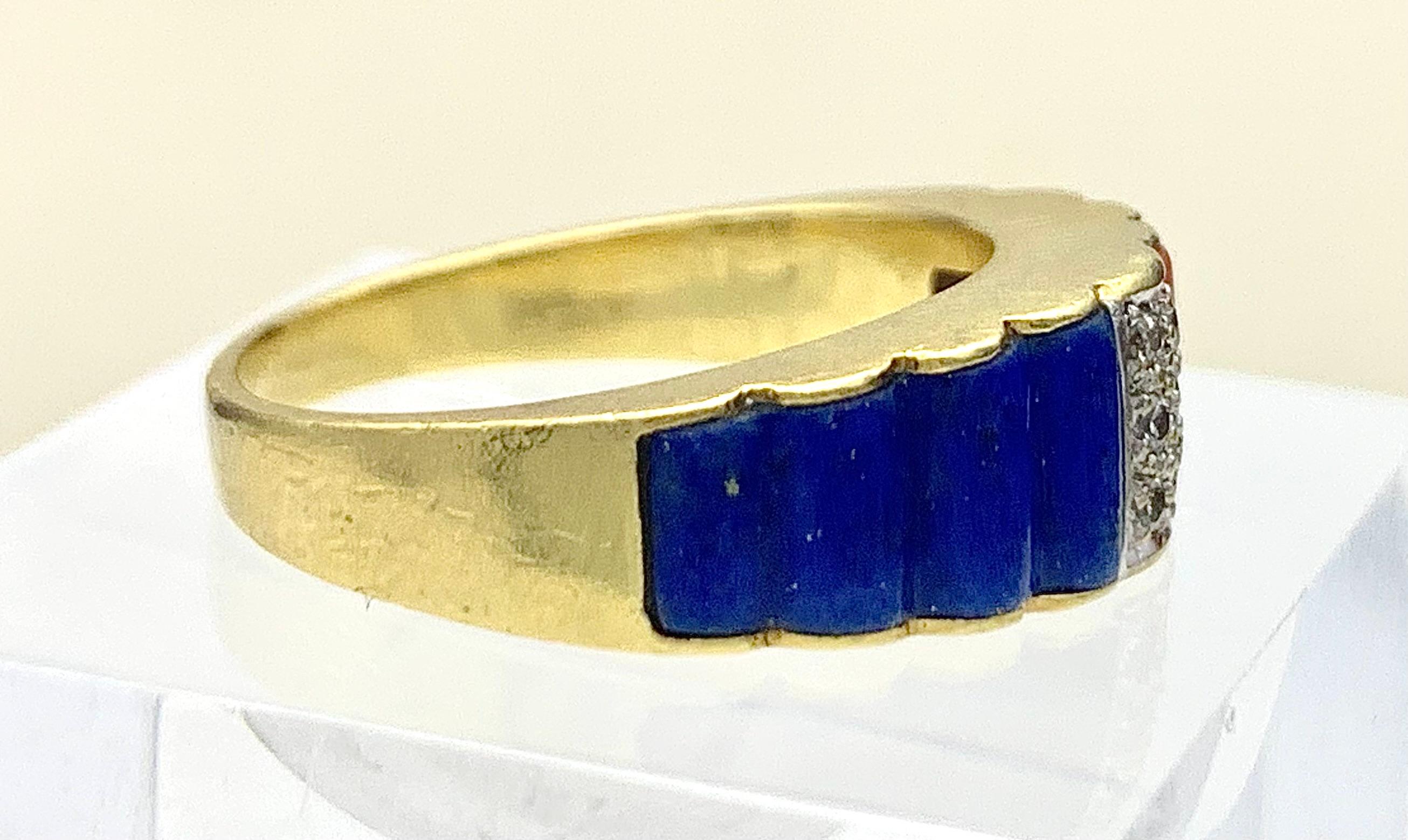 This elegant slightly domed band ring has been made out of 18 karat gold in 1970 ca. The outer borders of the ring head are designed as wavy sheets of gold that hold a piece of intense blue carved lapis lazuli on one side and a piece of deep orange