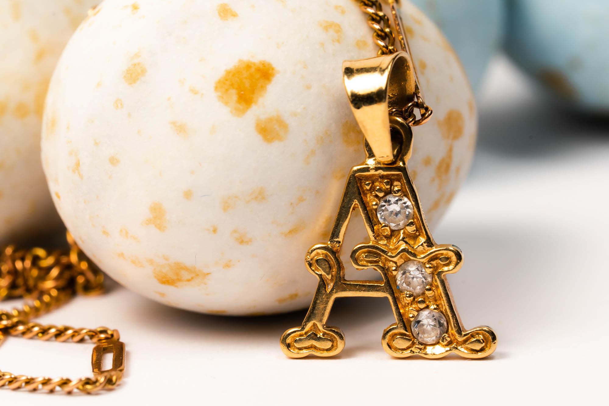 Here we have a lovely vintage 18k yellow gold letter A charm! 

The letter has a beautiful detailing and accented with three sparkling diamonds. On its bale its marked with a Masters' Mark and 18kt gold purity stamp.

This great vintage pendant will