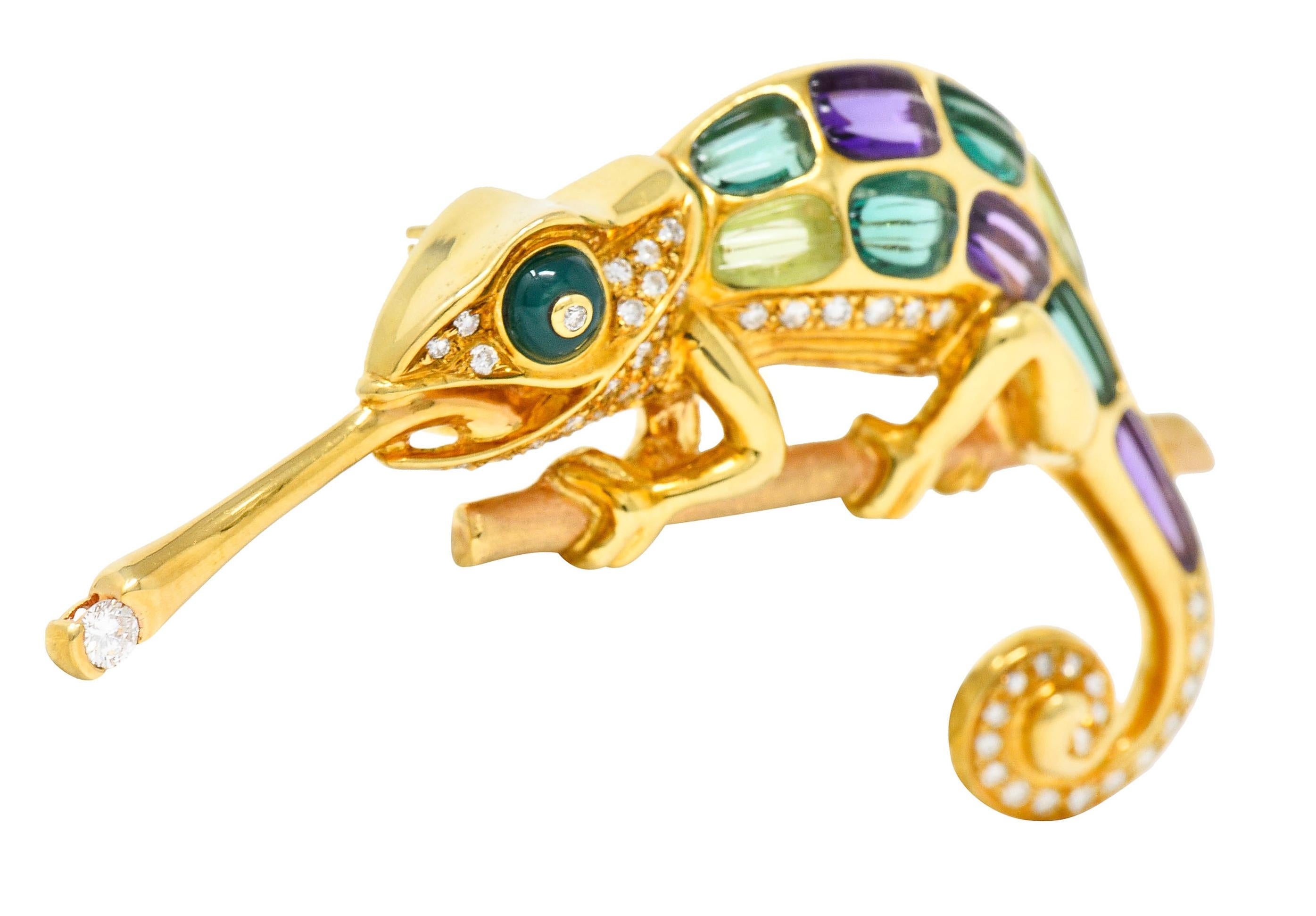 Designed as a highly stylized chameleon with a protruding tongue and a spiraled tail

Clutching a finely matte finished gold branch

Featuring a round chrysoprase cabochon eye with carved amethyst, chrysoberyl, and green tourmaline

Bead set with