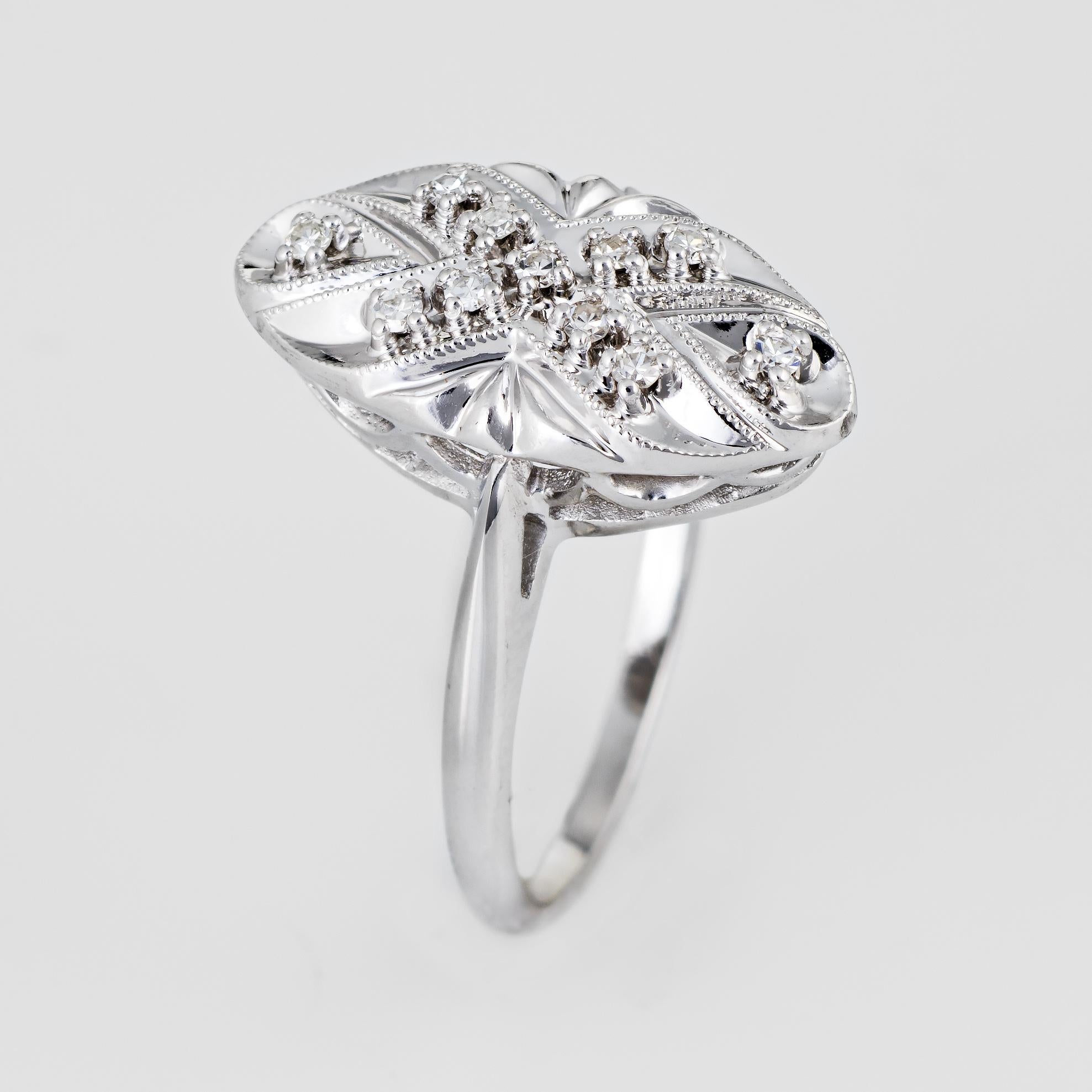 Stylish vintage diamond navette ring (circa 1950s to 1960s) crafted in 14 karat white gold. 

11 estimated 0.01 carat single cut diamonds total an estimated 0.11 carats (estimated at I-J color and SI1-I1 clarity). 

The navette ring is set with