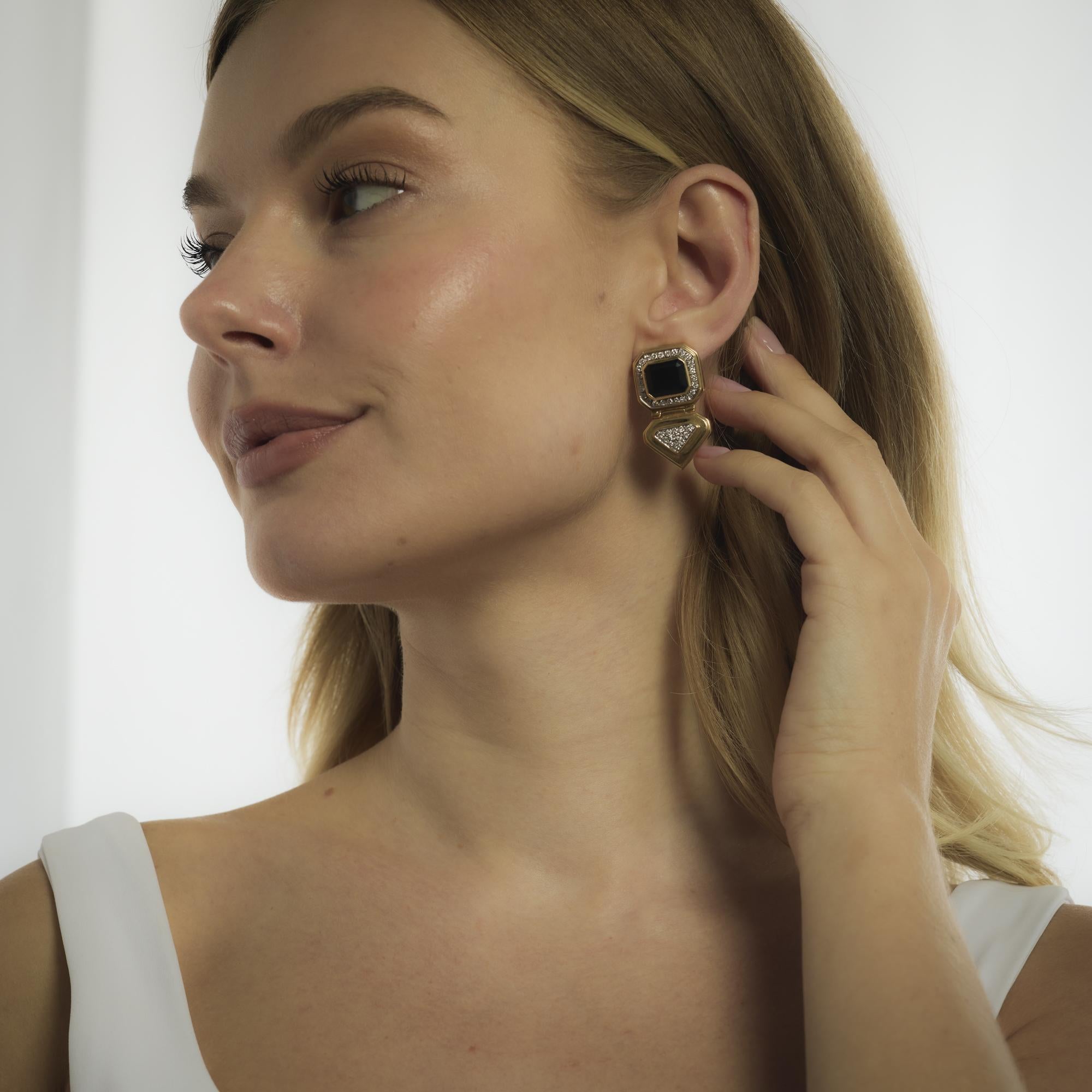 These vintage 14k yellow gold earrings from the 1970’s shimmer with seventy-four round brilliant cut diamonds totaling approximately 1.50 carats in G-H color and VS clarity. Bold onyx accents provide a striking contrast to the bright sparkle of the