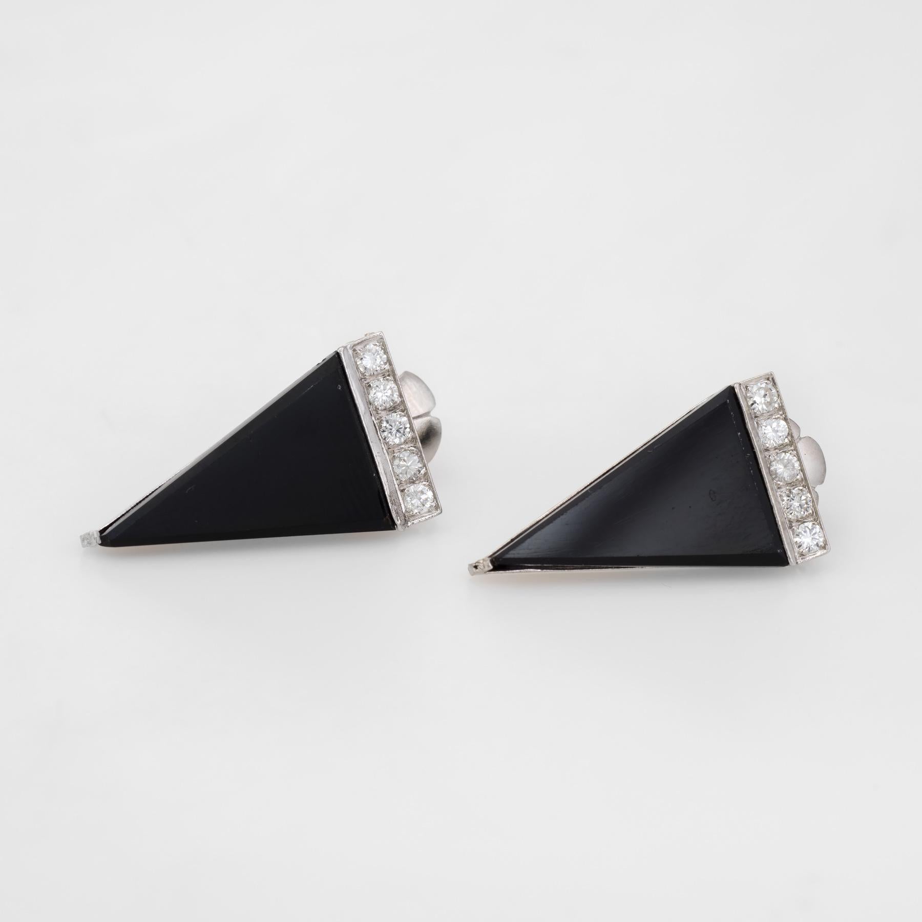 Striking pair of vintage triangle earrings, crafted in 900 platinum. 

Onyx is triangular cut and measures 19mm x 11mm, accented with a row of round brilliant cut diamonds. The 10 diamonds are estimated at 0.04 carats each, totaling an estimated