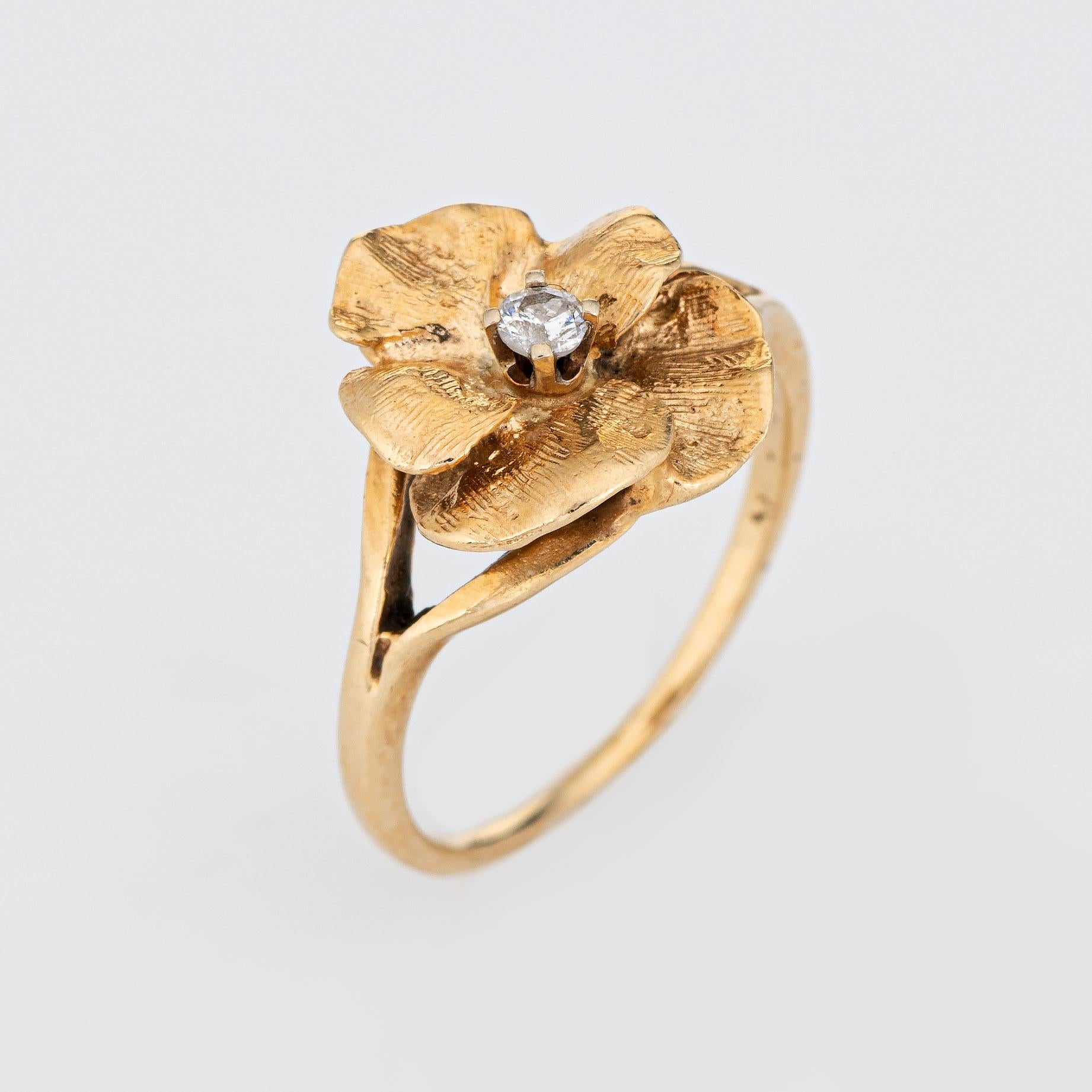 Stylish vintage diamond pansy ring (circa 1960s to 1970s) crafted in 14 karat yellow gold. 

One estimated 0.05 carat diamond is set into the mount (estimated at H-I color and I2 clarity). 

The sweet pansy features a muted brushed gold effect with