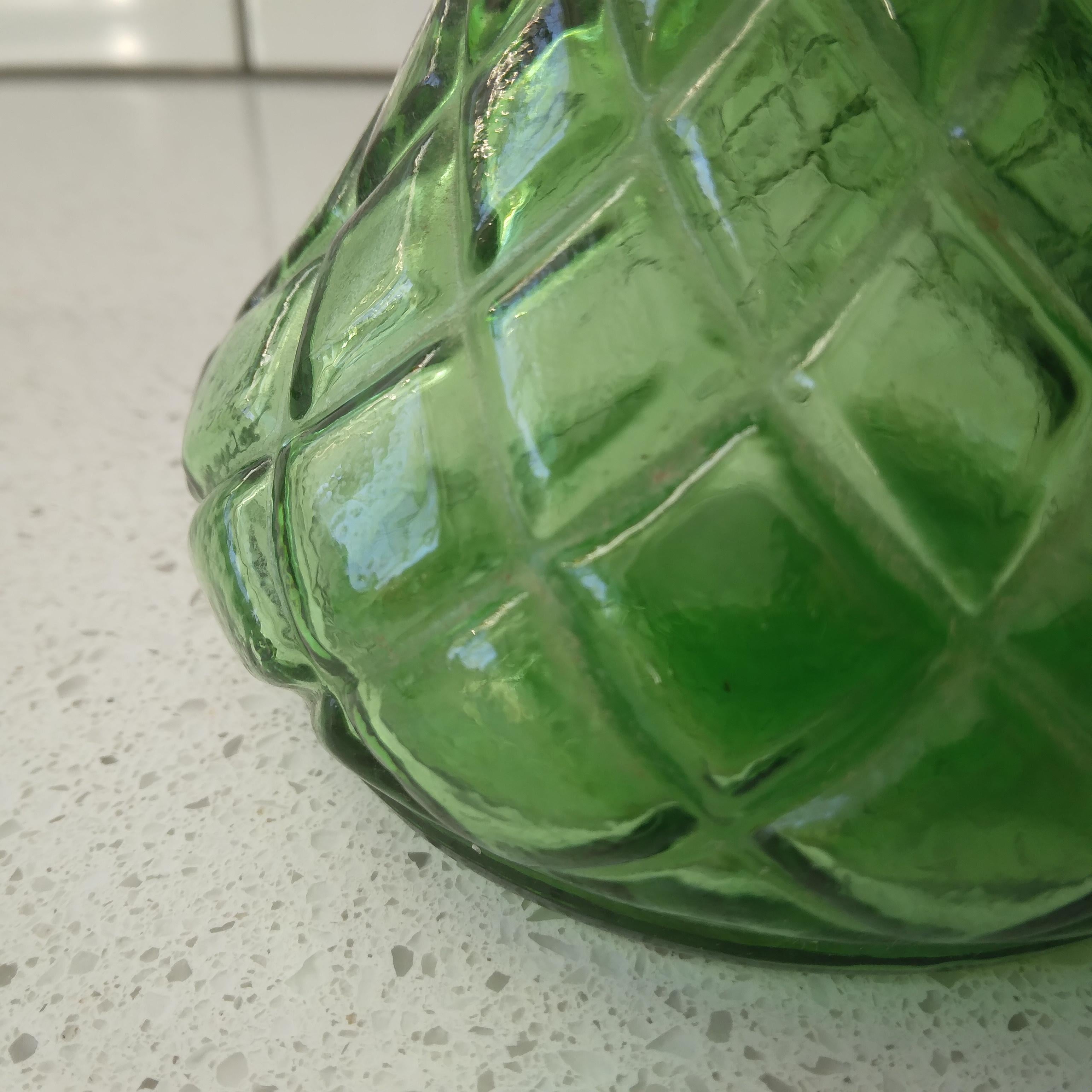 Bottle green glass in a adorable quilted diamond design, this vintage bud vase is ready to display the beauty of nature. We love her vibrant color and generous, bell-shaped curves!  

Meant to highlight the beauty of a single flower or small
