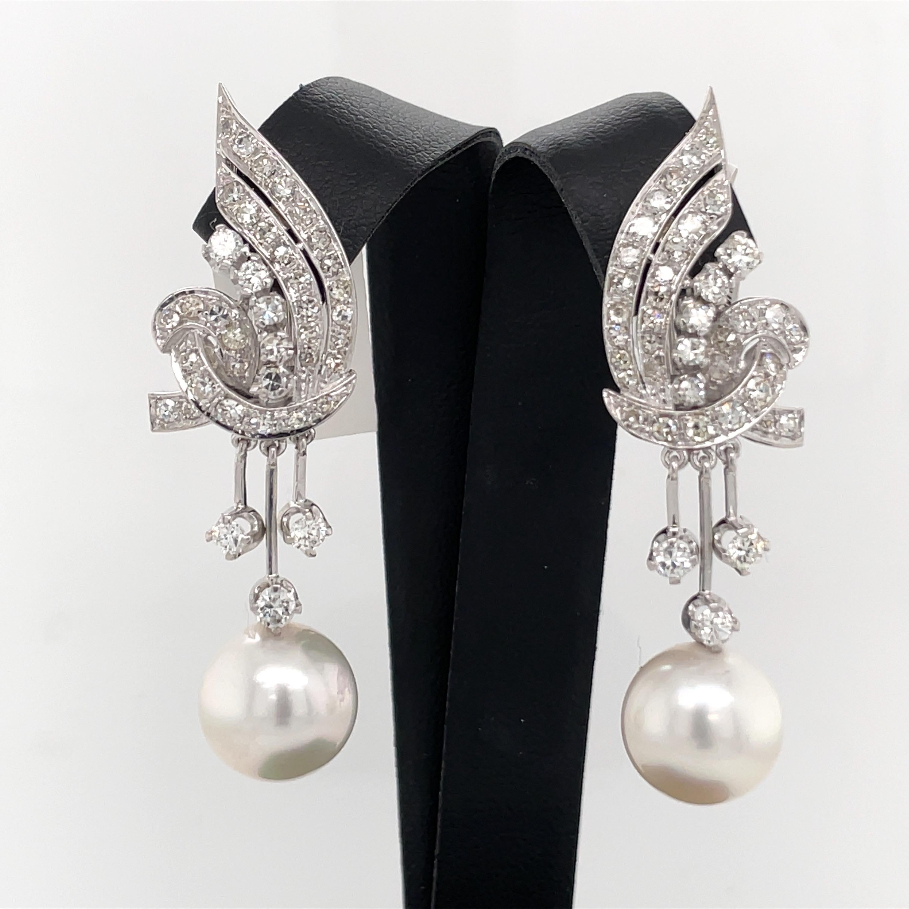 Vintage Platinum diamond drop earrings featuring round brilliants weighing approximately 2 Carats and a white pearl measuring 11.5 mm. 
Post can be put on earring. 