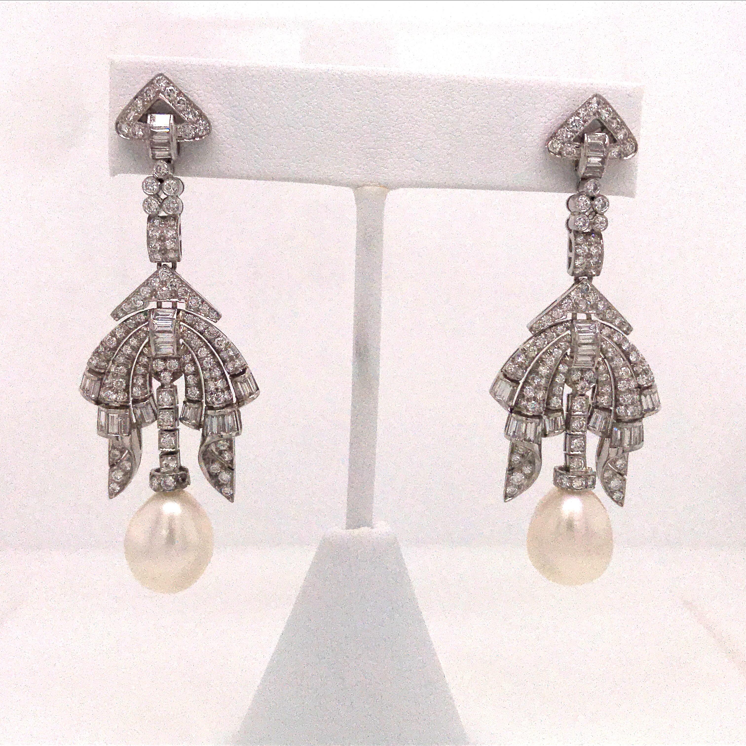 Circa 1950's drop earrings featuring numerous round diamonds and baguettes weighing approximately 4.50 carats and two oval shape pearls measuring 12 mm.

Very Dramatic!!