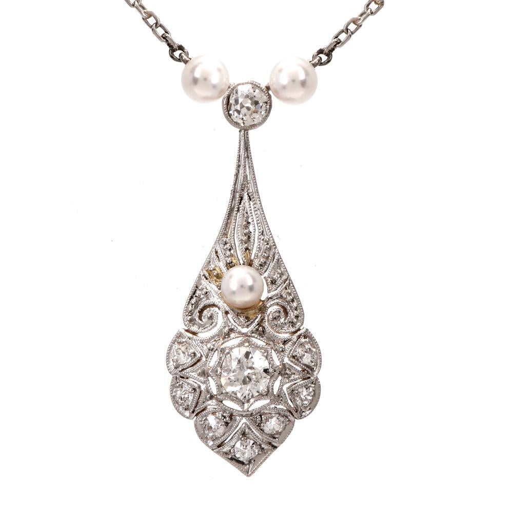 This antique diamond and pearl chain necklace is crafted in 18K gold with a solid platinum top and a platinum chain. Showcasing an interact open work tear drop pendant covered in round-cut diamonds approx. 0.85cts, H-I color, VS-SI clarity. Further