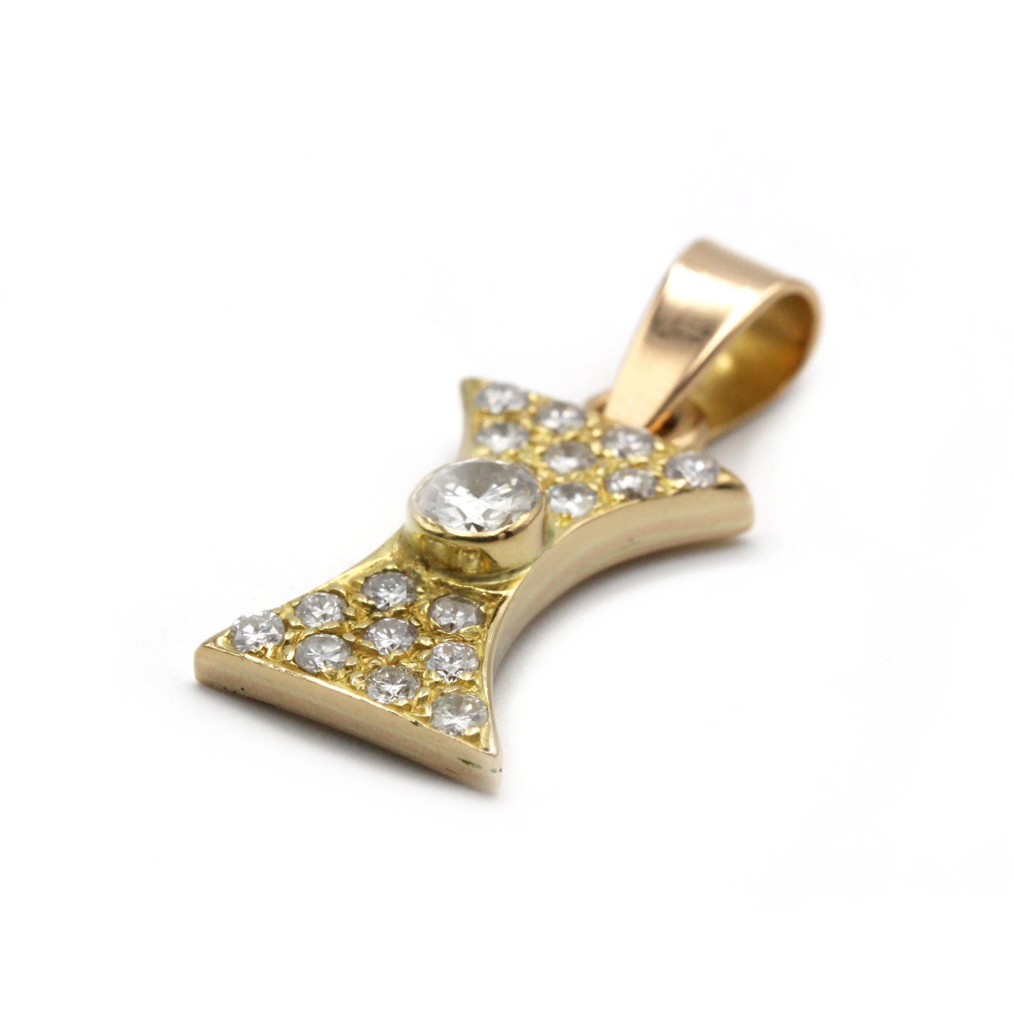 This vintage pendant in 18k yellow gold is a true statement of elegance and geometric sophistication. Designed in an hourglass silhouette, it features a centrally bezel-set brilliant-cut diamond of approximately 0.35 carat. Surrounding it, 18