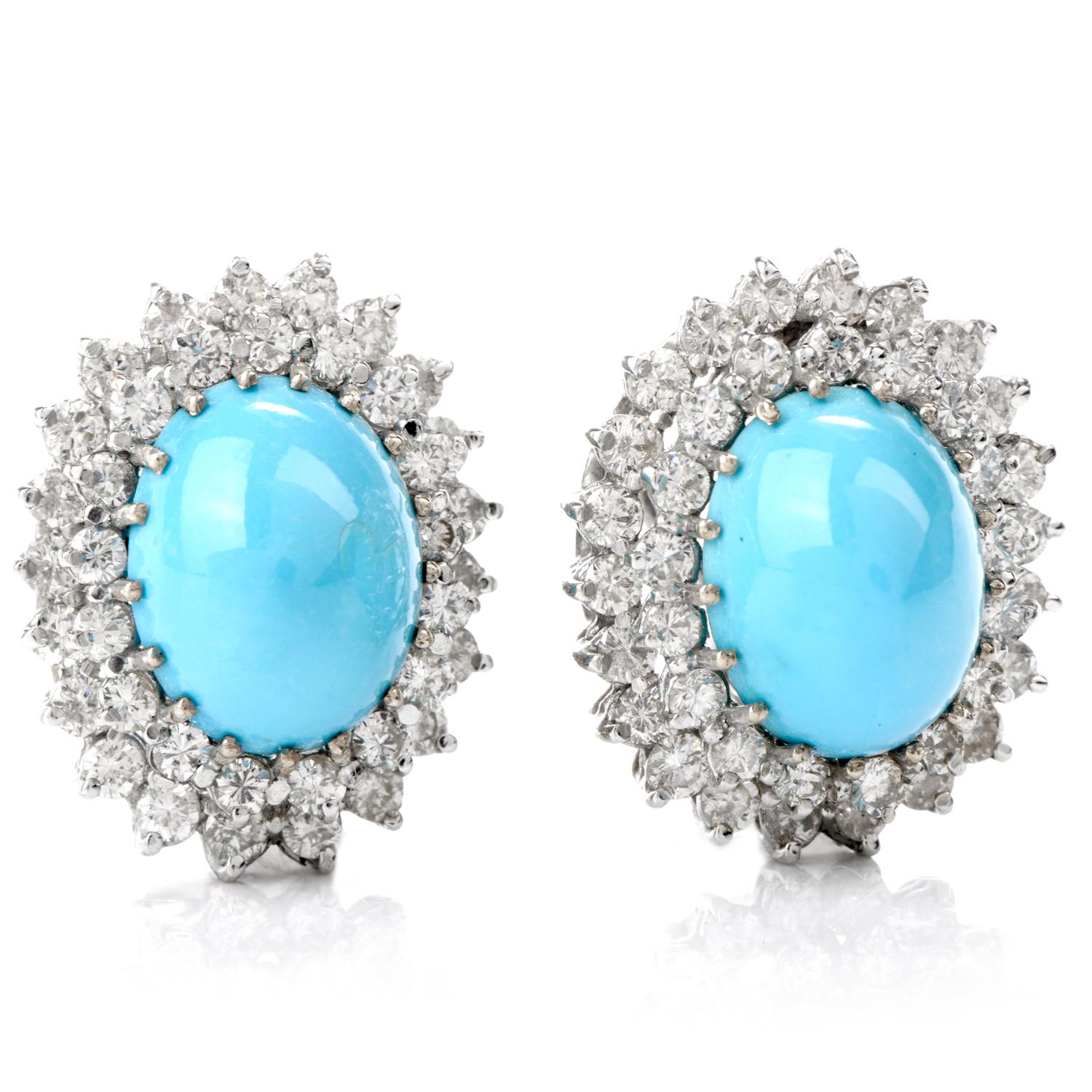 This Vintage 1960's pair of Diamond and Persian Turquoise earrings were inspired with a Double Halo and crafted in 14.0 grams of 14k white gold. The focus and prominent center each contain an oval cabochon cut Turquoise measuring approximately
