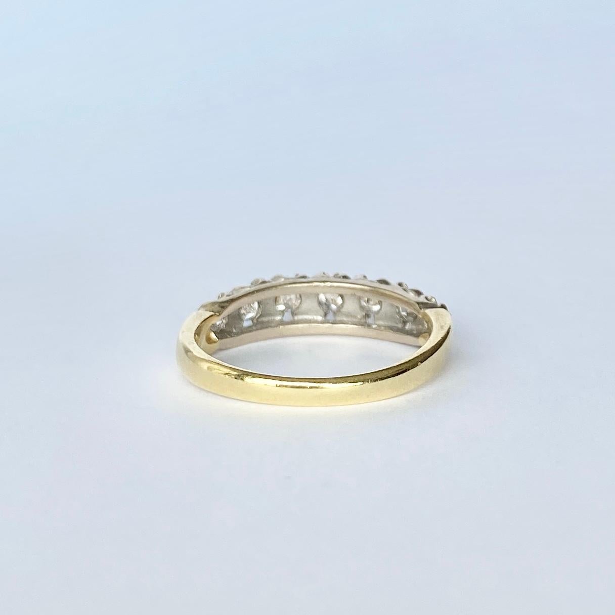 On top of this simple 18 Carat Gold band sits seven bright diamonds with a total weight of 70pts. The diamonds have platinum detail around them and the ring has a chunky feel. 

Size: M or 6 1/4 
Band Width: 5mm

Weight: 4g