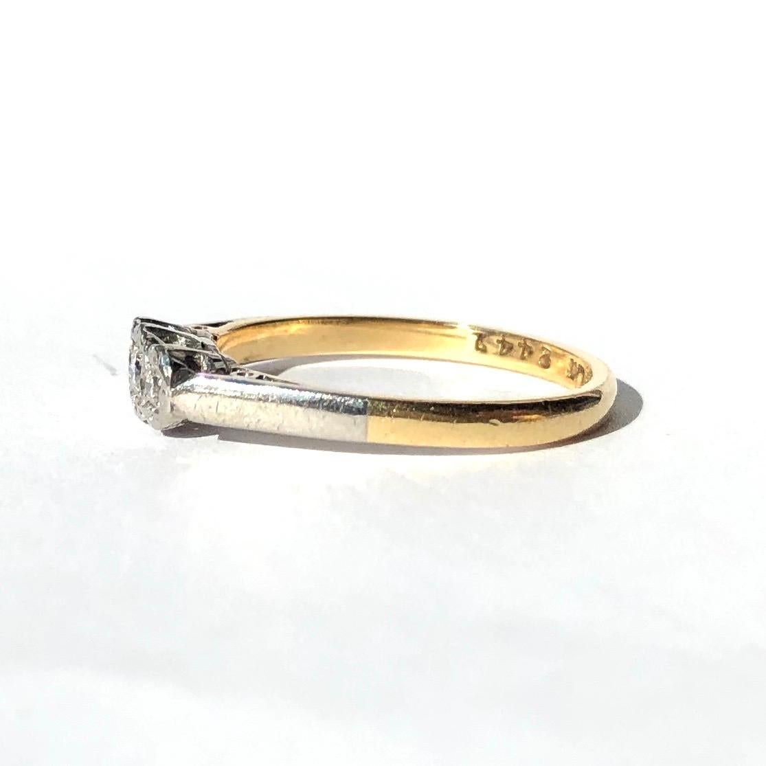 The setting and the shoulders of this three stone ring are modelled in platinum and the rest of the ring is modelled in 18ct yellow gold. The three sparkly diamonds are set in illusion settings. The central stone measures 7pts and the ones either