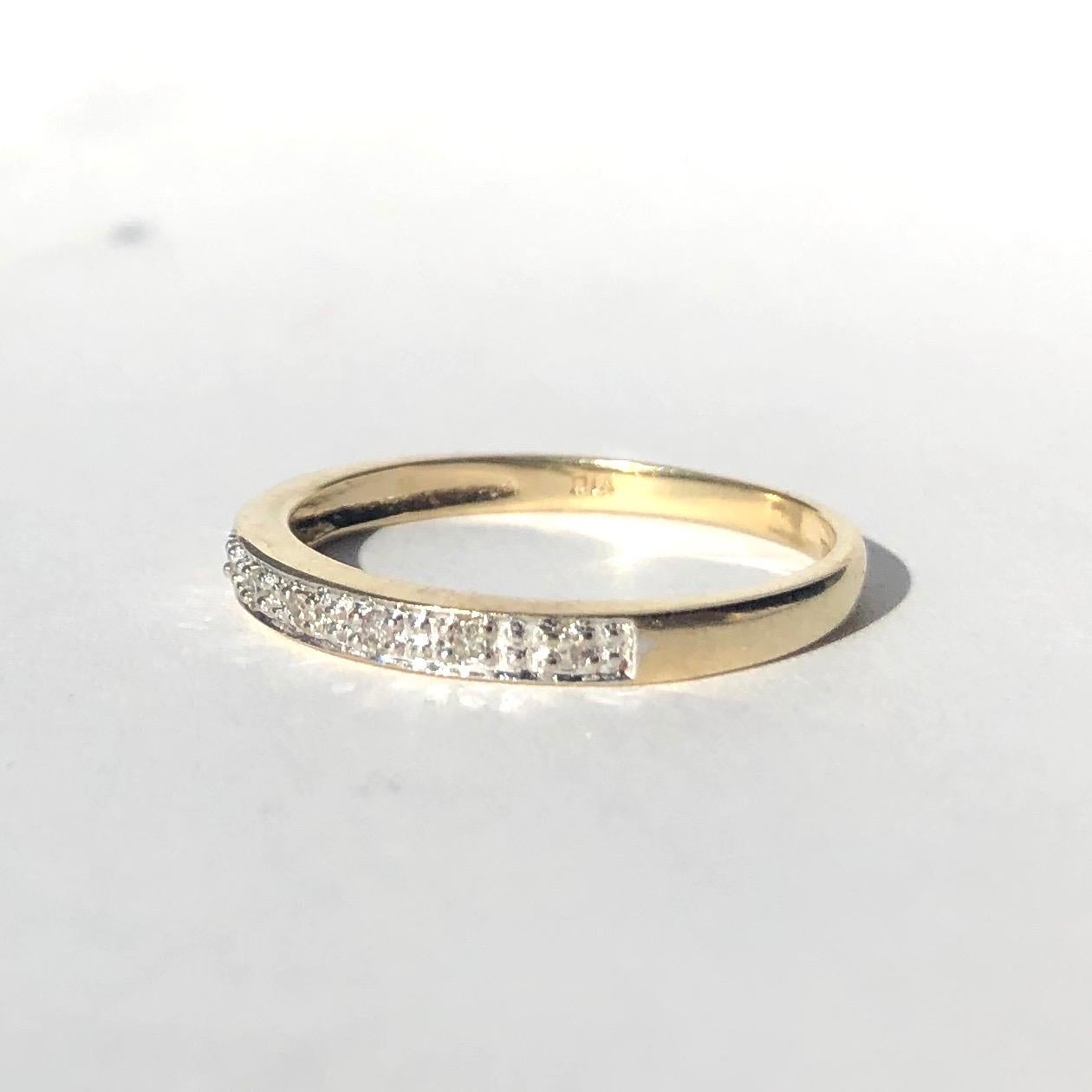 The eight diamonds measure 2pts each and are set in platinum which gives the illusion of a non stop row of diamonds. The diamonds are bright and sparkly and the platinum next to the 9 carat gold give a modern look to the ring. 

Ring Size: N 1/2 or
