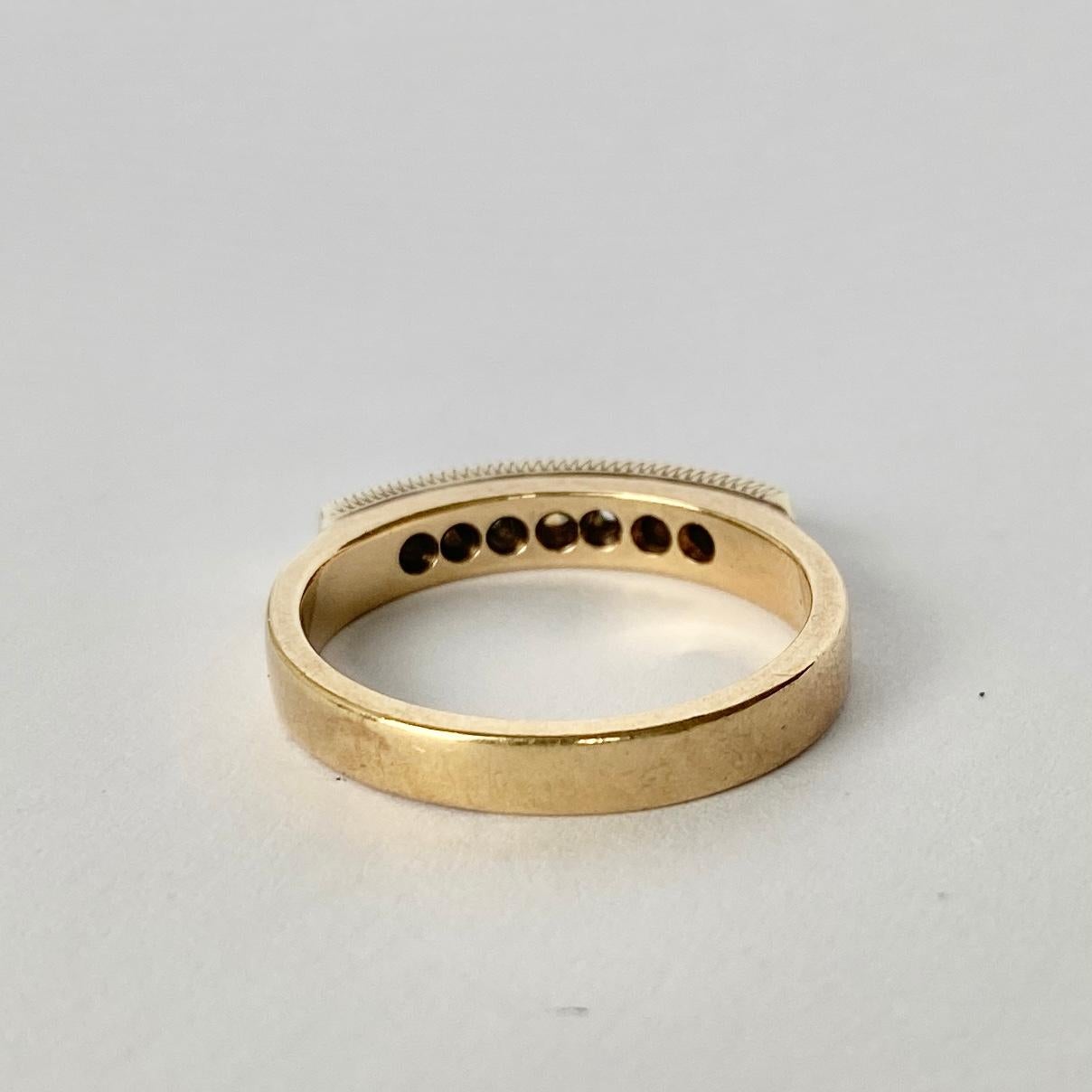 On top of this simple 9 Carat Gold band sit seven bright diamonds with a total weight of 40pts. 

Ring Size: N or 6 3/4 
Band Width: 3.5mm

Weight: 3.9g