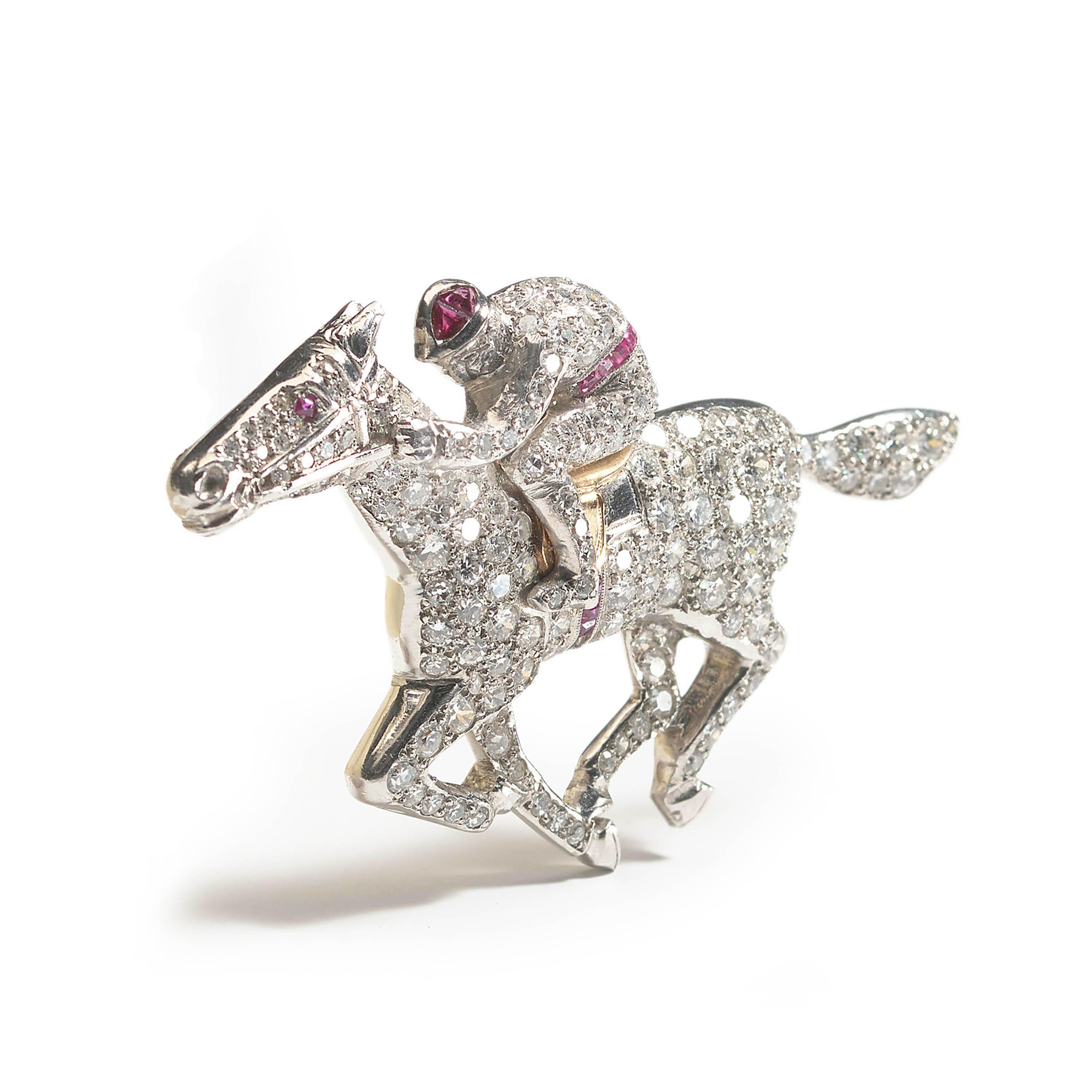 A vintage horse and jockey brooch, pavé set with eight-cut, old-cut and round brilliant-cut diamonds and calibré-cut rubies in the horse's saddle girth, the jockey's cap and belt and a round ruby in the eye, mounted in platinum, with a gold saddle,