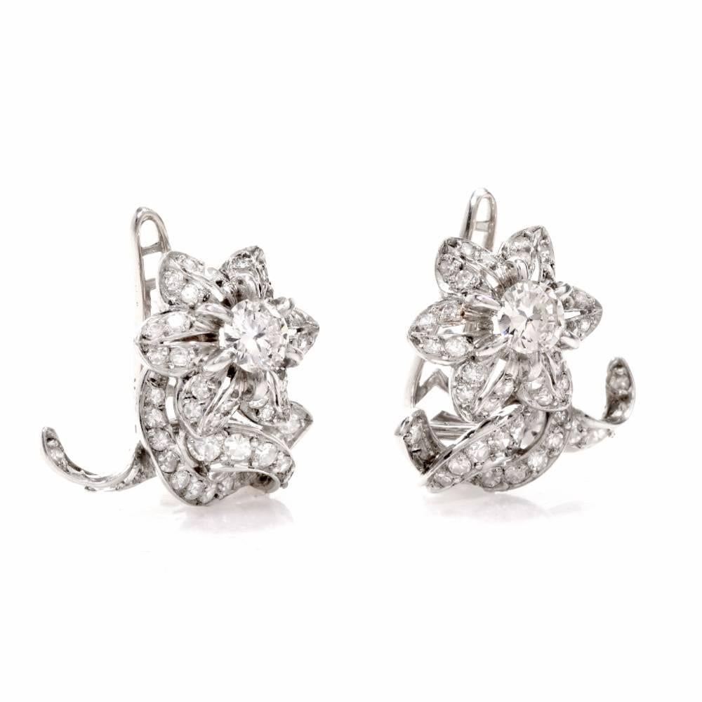 These enchanting vintage earrings of naturalistic inspiration depict each a botanically accurate diamond-swathed 6-petal flower, positioned above two overlapping diamond-studded stems.The earrings weigh 13 grams and measure 22 mm x 20 mm.  The