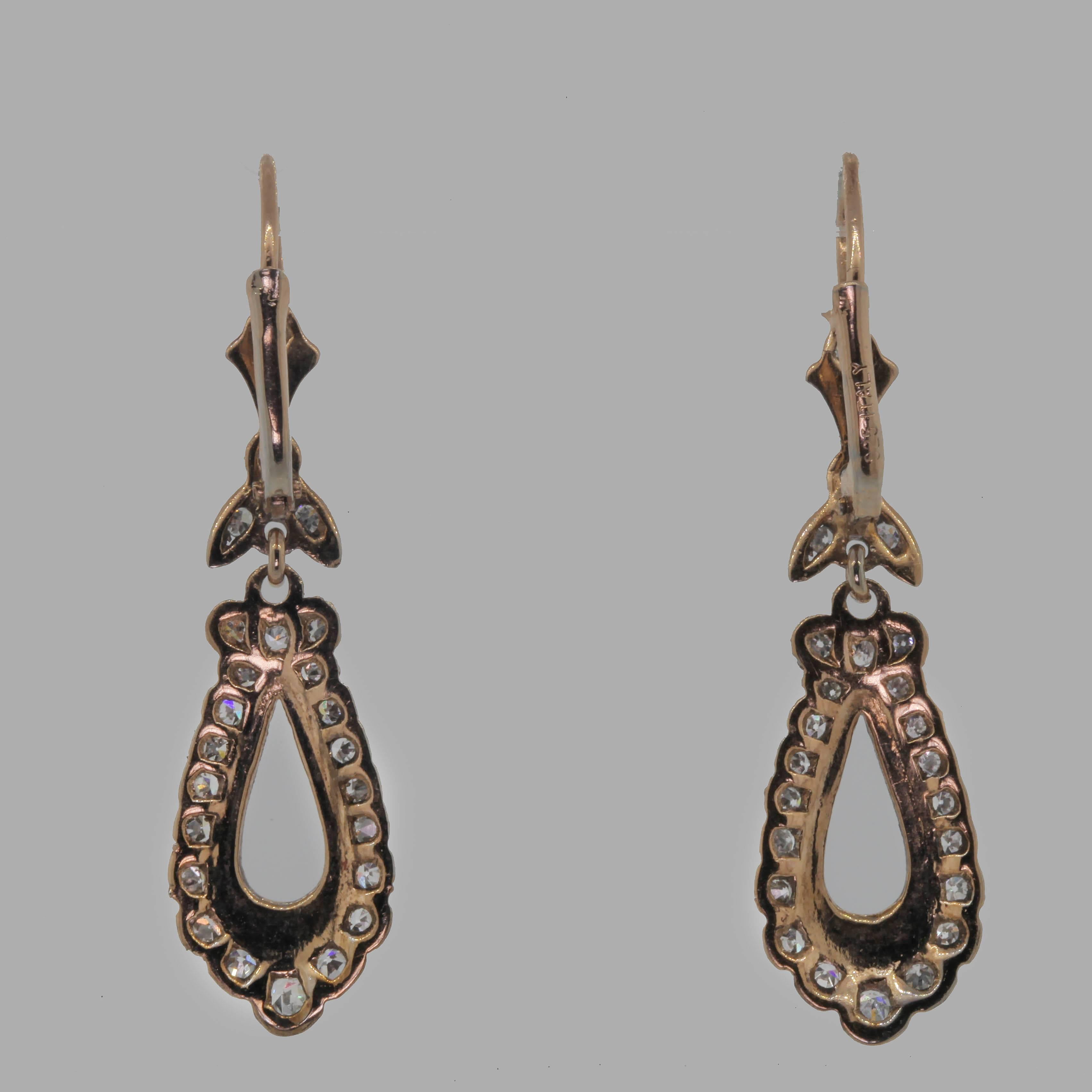 Beautiful dangling platinum 18KT yellow gold earrings.  The pear shape with floral design tops are set with 1. 15 carat of Single Cut Diamonds all of  H/I color - VS/SI and are completed with hooks and lever backs.  Simply Romantic! Circa 1960s.