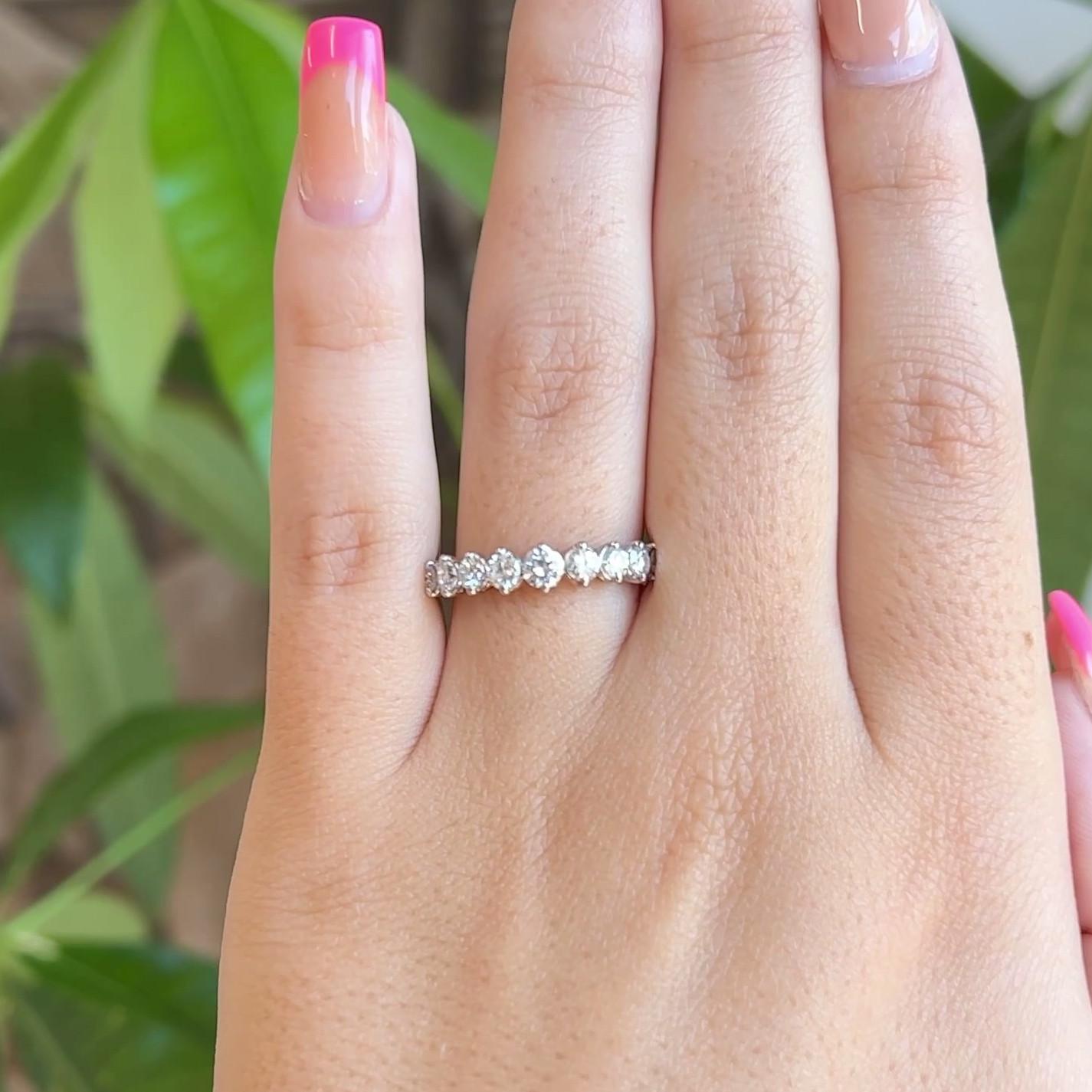 One Vintage Diamond Platinum Half Eternity Band. Featuring nine round brilliant cut diamonds with a total weight of approximately 0.85 carat, graded F color, VS clarity. Crafted in platinum. Circa 1990. The ring is a size 6 and may be resized.