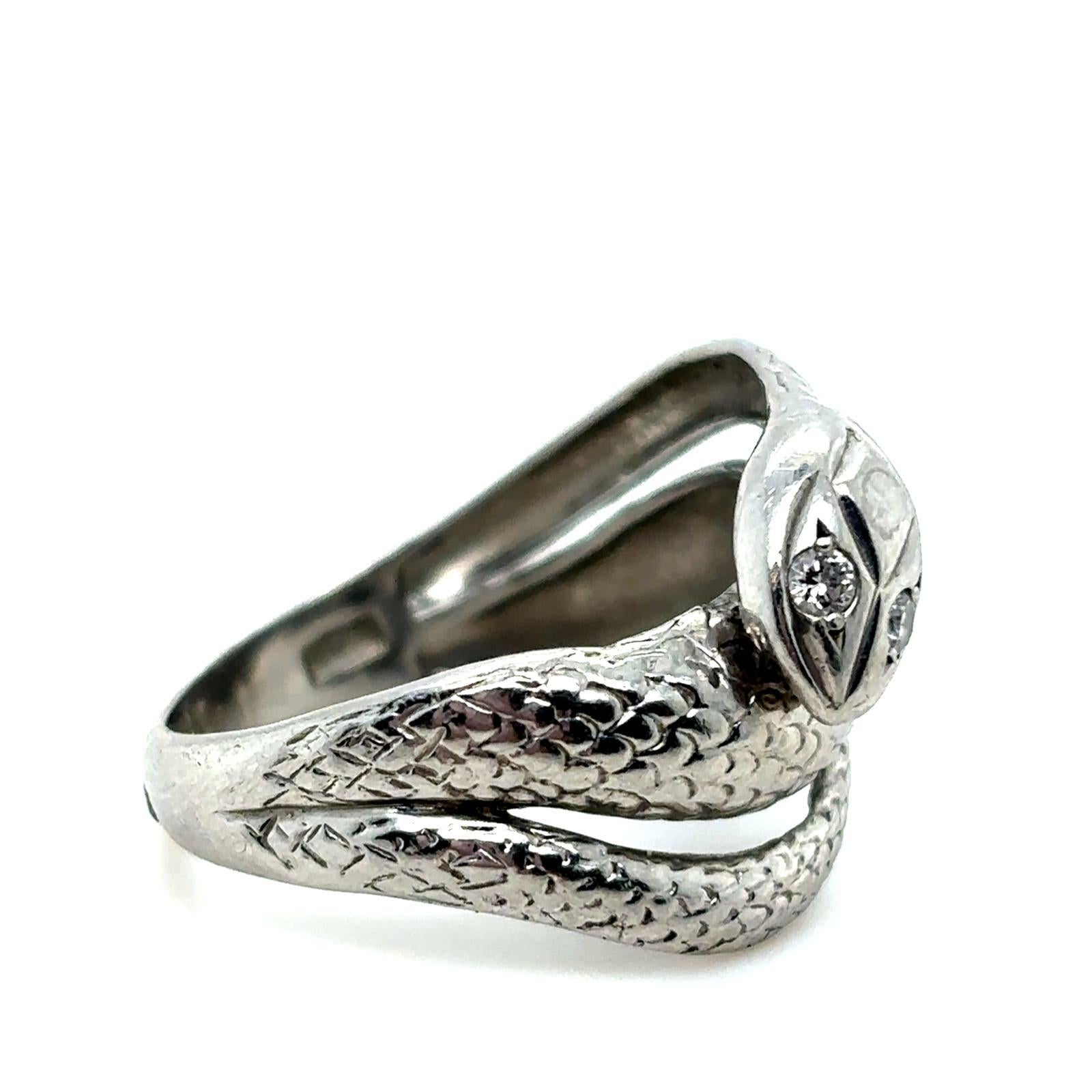 A vintage diamond platinum snake ring, circa 1970

This charming snake ring, coils twice around the finger of the wearer.

Crafted as a realistically modelled snake and grain set with round brilliant cut diamond eyes of 0.04 carat approximately,