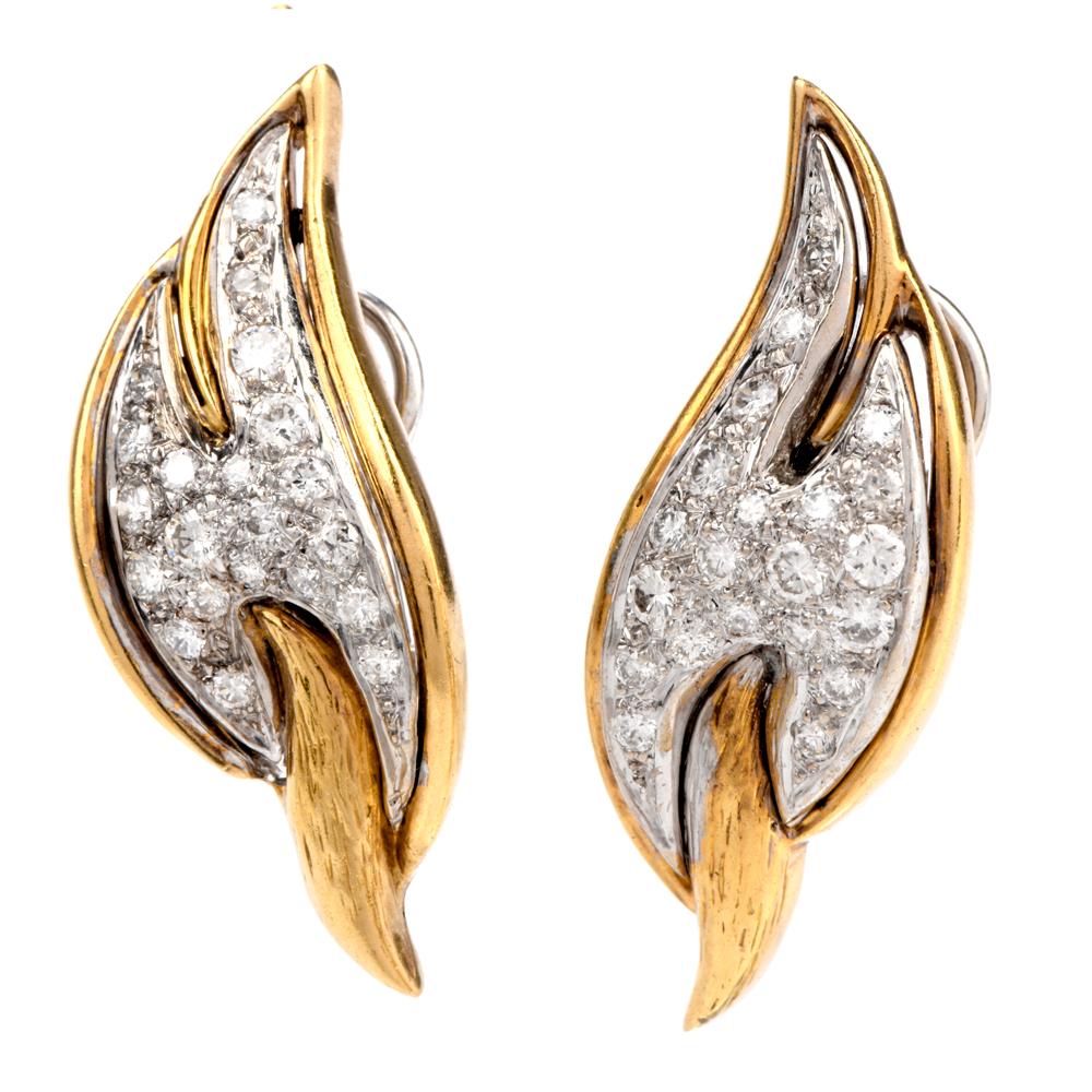 These stunning 1960s diamond earrings are crafted in a combination of platinum and 18-karat yellow gold, weighing 11.8 grams. Displaying a swirled design pave-set with 44 round diamonds, weighing approximately 1.20 carats, graded G-H color and