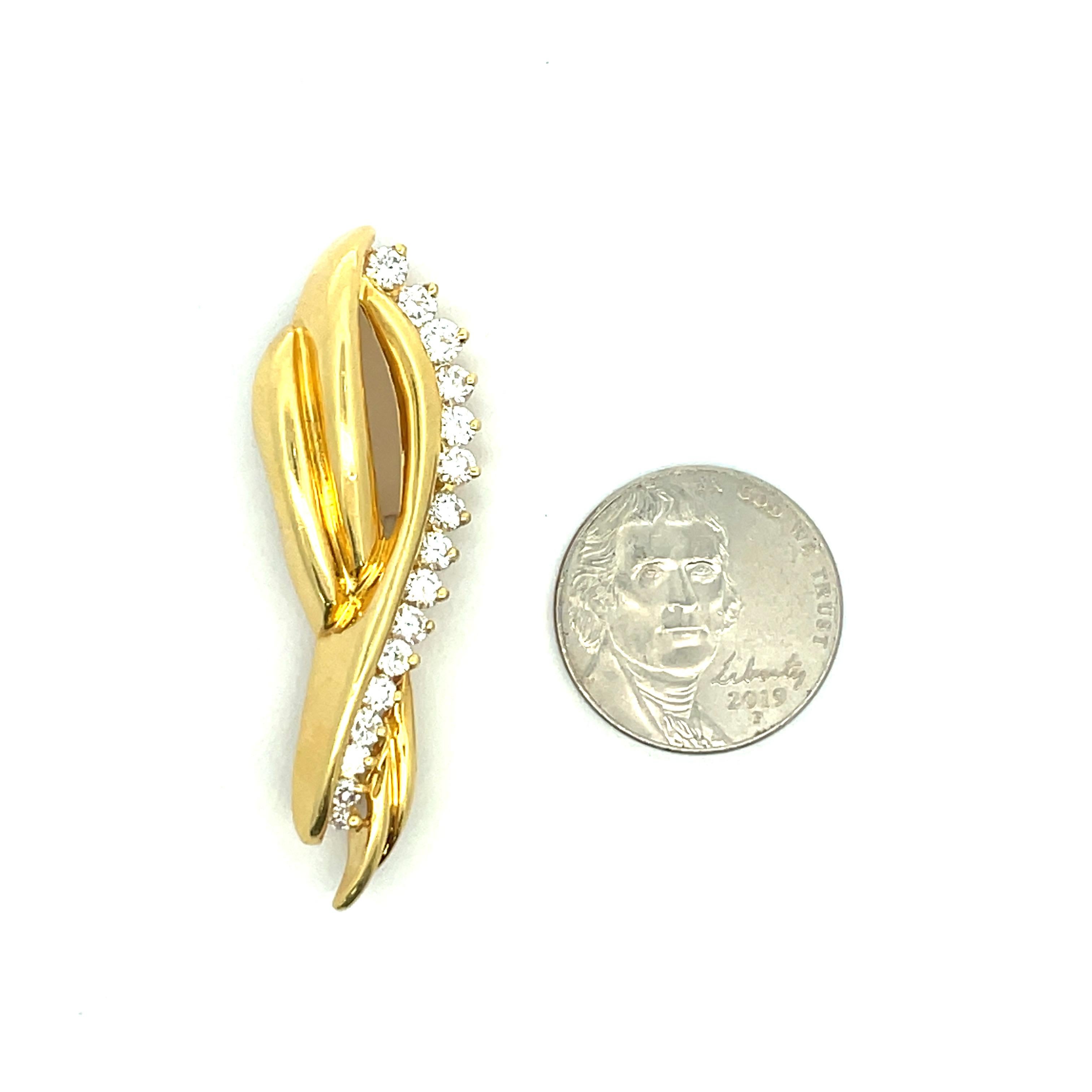 One Vintage 'Ribbon' motif brooch containing 16 round brilliants weighing approximately 1 Carat in 18 Karat yellow gold. 