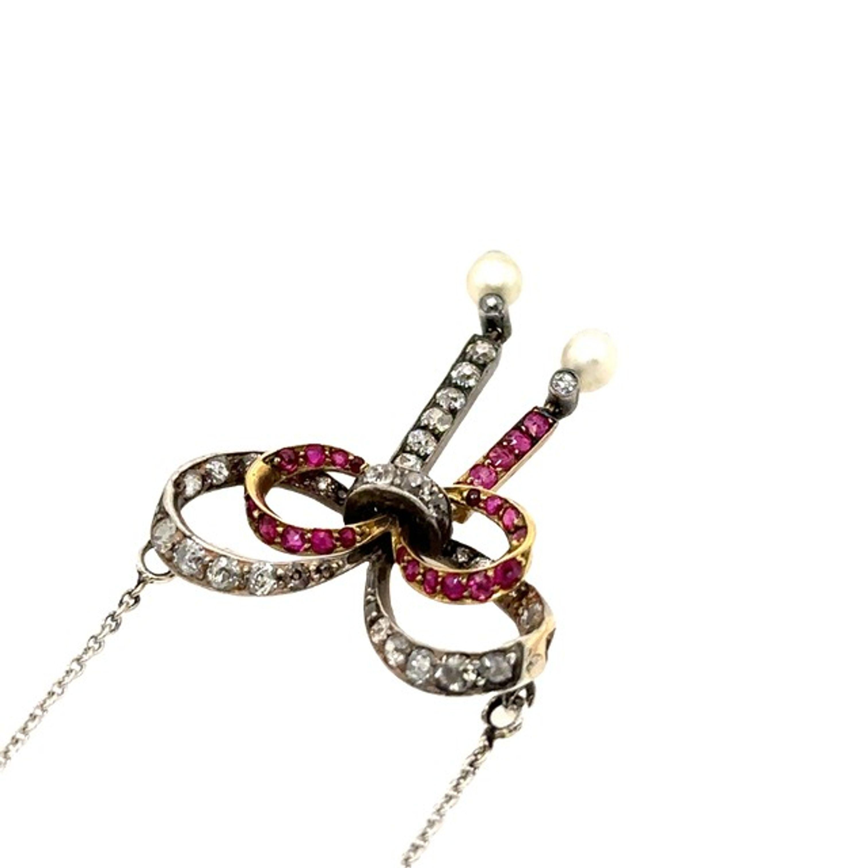 Vintage Diamond & Ruby Bow Pendant Suspended from 14ct Gold Chain In Excellent Condition For Sale In London, GB