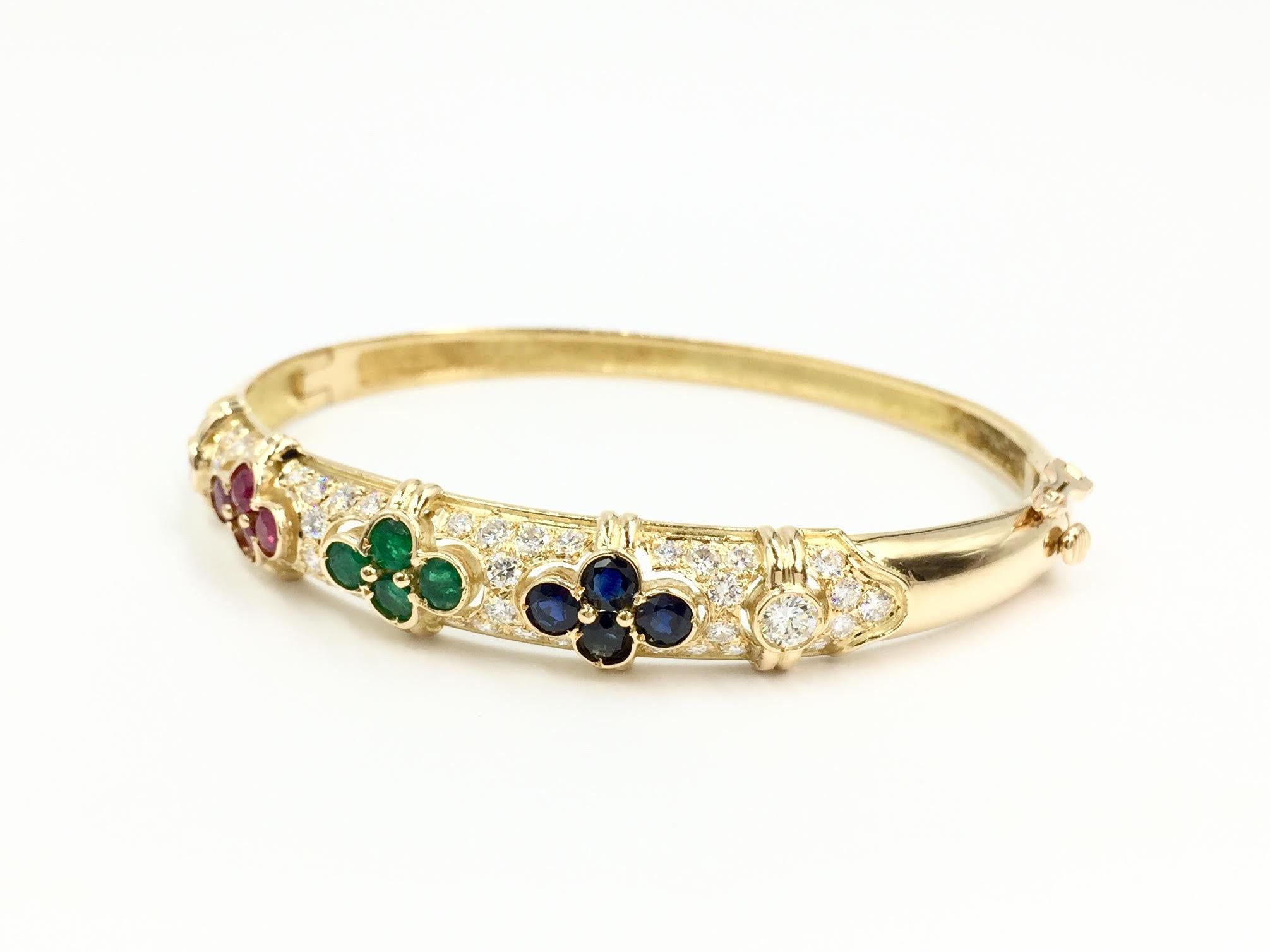 Circa 1960's, this beautiful polished 18 karat yellow gold oval bangle bracelet features high quality diamonds at 1.66 carats total weight. Diamonds are approximately E color, VS1-VS2 clarity with incredible sparkle. Colored precious gemstones are