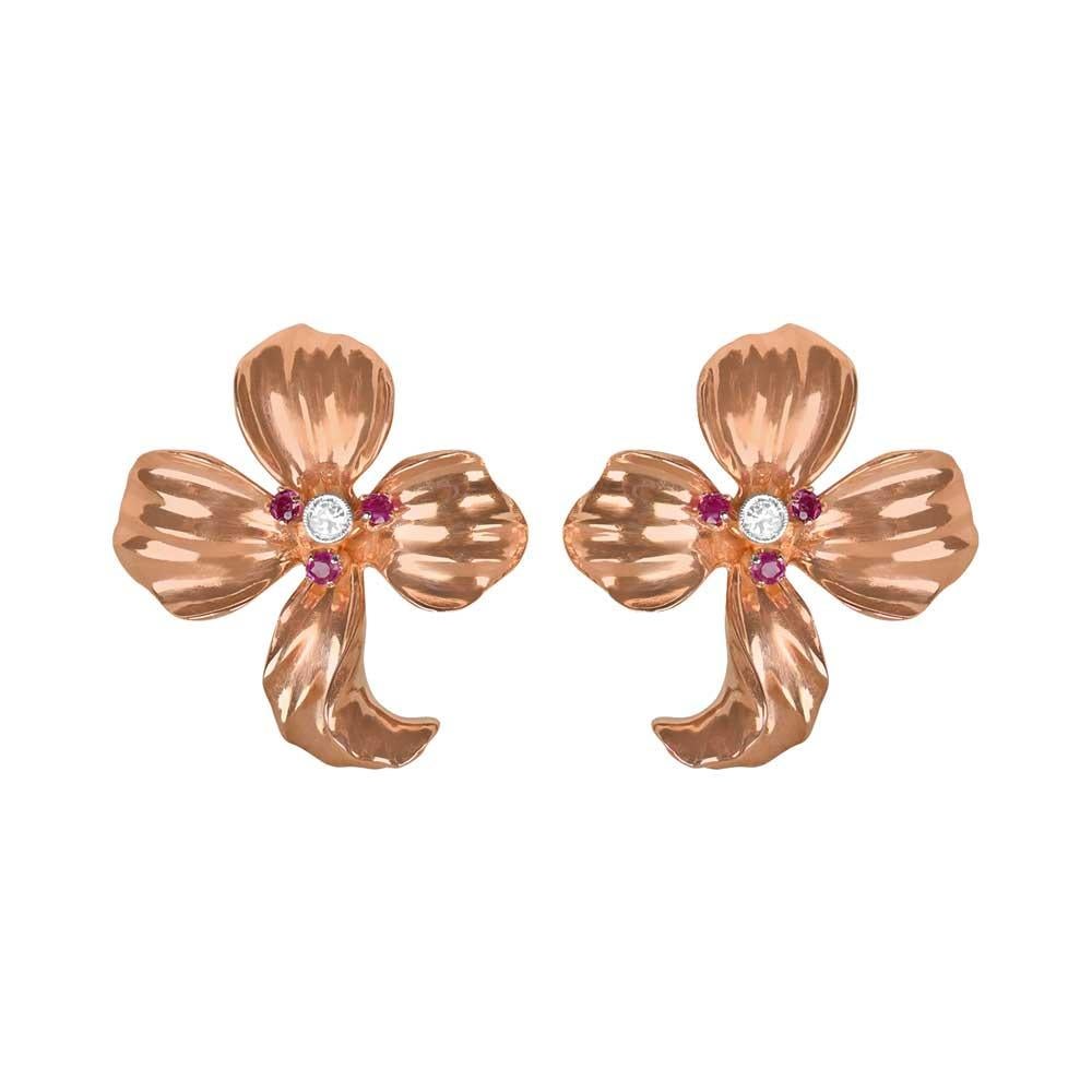 Embrace the Retro era's charm with these vintage floral earrings. Gracing each earring is a single-cut diamond and three round-cut rubies nestled amid four delicate petals. The diamonds, weighing around 0.10 carats combined, gleam from bezel