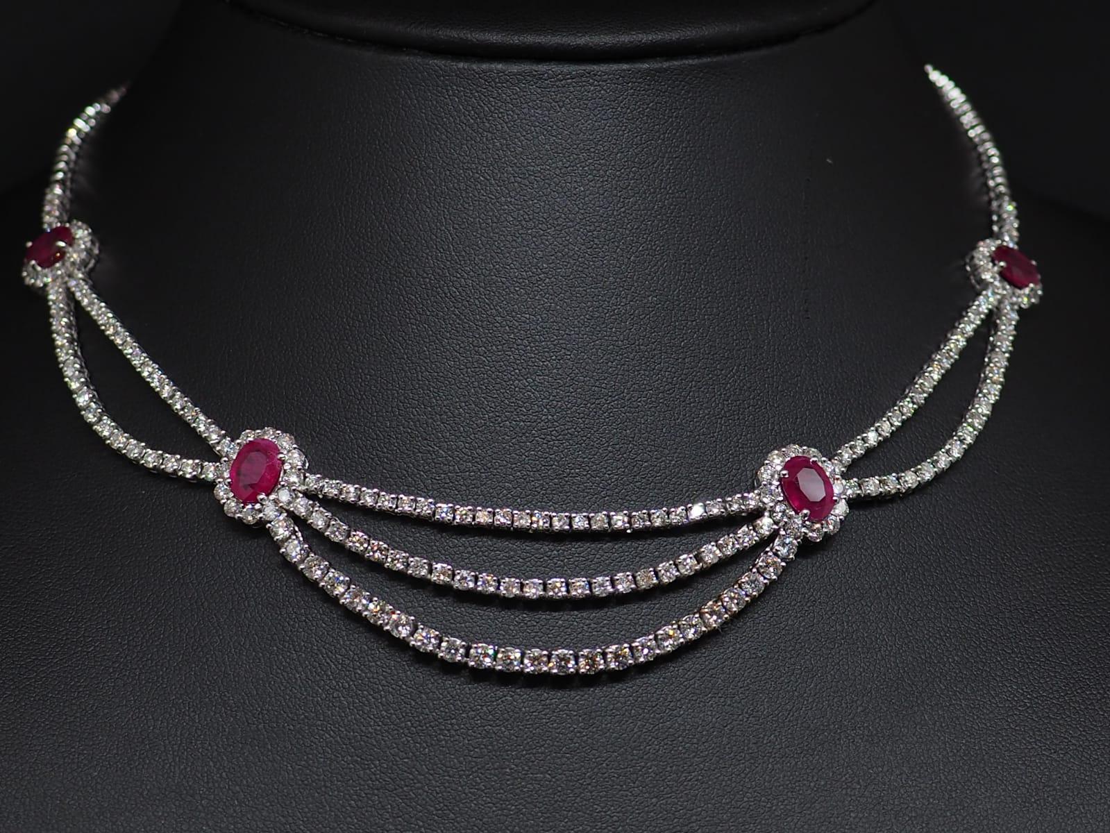 A gorgeous 18K diamond and ruby tennis necklace. It features 155 brilliant-cut round diamonds with a total weight 5.65 carats and 4 oval rubies with a total weight 10.8 carats. 4 not-heated rubies surrounded by diamond crowns divide the necklace in