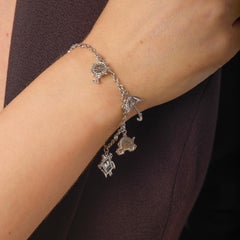 Bracelet à breloques en or blanc 18k, diamant, rubis et saphir vintage