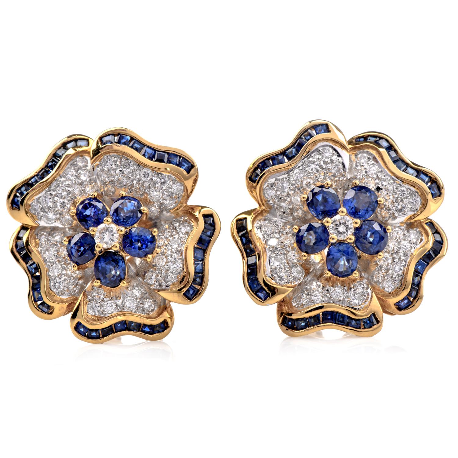These exquisite Pair of vintage 1980s earrings are adorned with a captivating flower motif. Crafted from solid 18K yellow gold. These Vintage earrings feature a halo of oval sapphires encircling a dazzling diamond center. The leaves of the flower