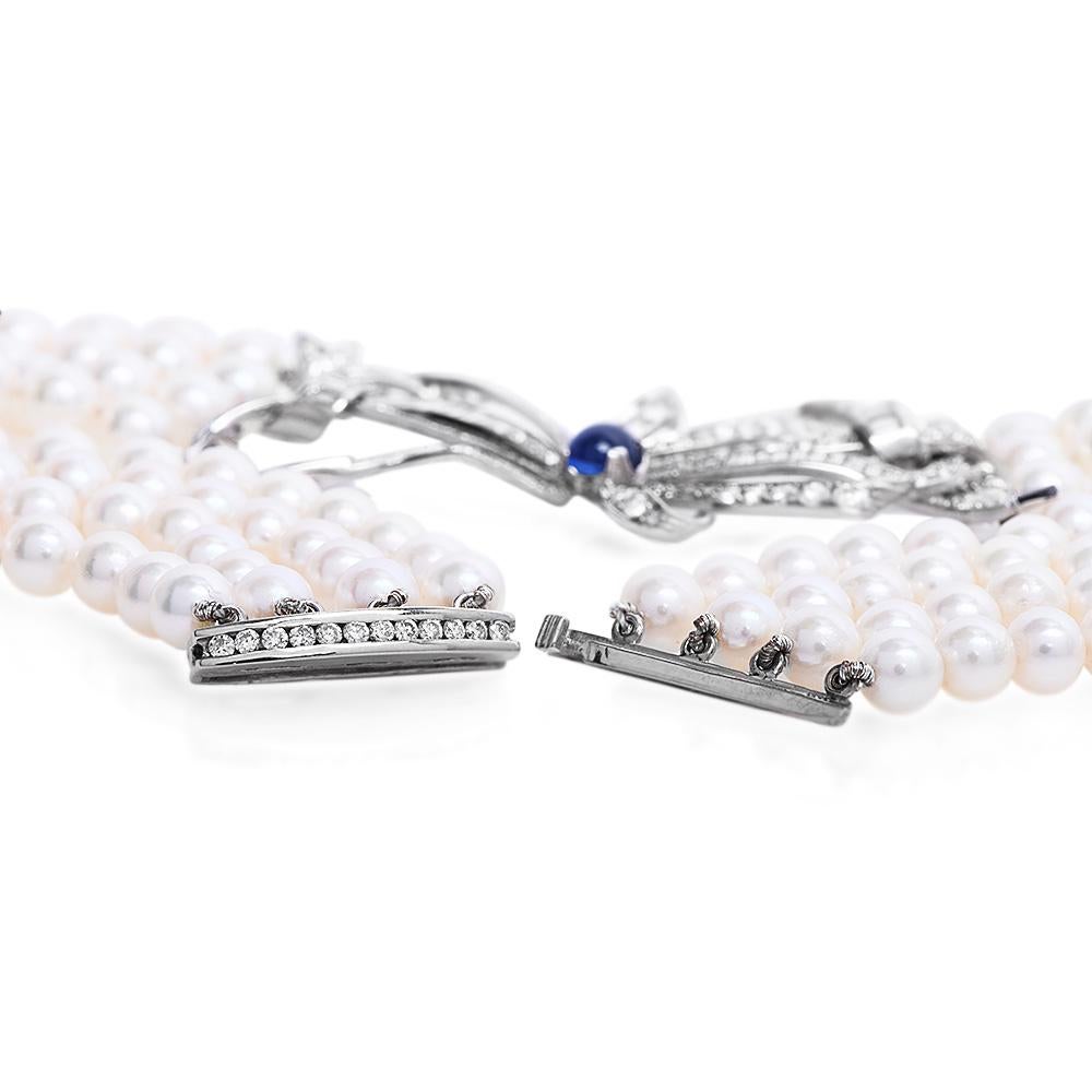 Collier pendentif vintage à plusieurs rangs de perles avec nœud papillon en platine, diamant et saphir Pour femmes en vente