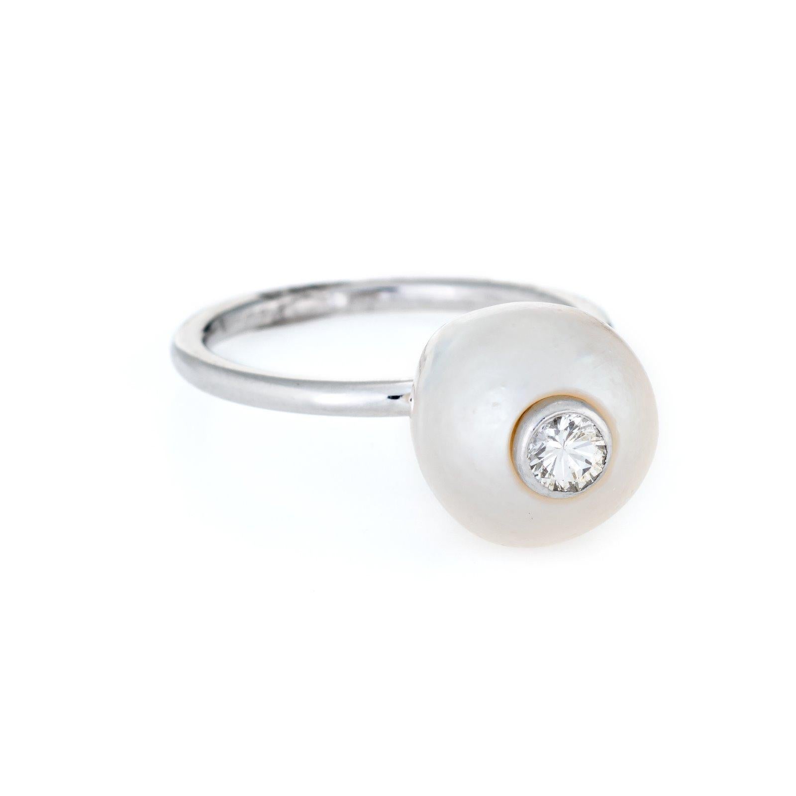 Finely detailed estate cultured pearl & diamond ring, crafted in 14 karat white gold. 

The cultured pearl measures 10mm with a diamond inset into the pearl (estimated at 0.05 carats - H-I color/VS2 clarity). The stones are in excellent condition