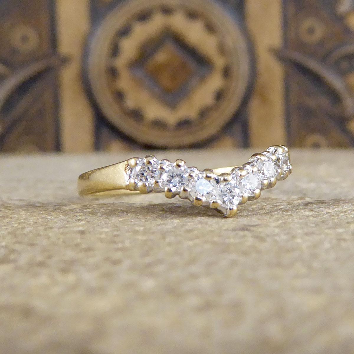 Featuring a delicate wishbone design, this 9ct Yellow Gold is adorned with sparkling Diamonds. Its slender gold band holds seven Modern Brilliant Cut Diamonds weighing a total of 0.25ct and its a class and beautiful design. 

Diamond Details:
Cut: