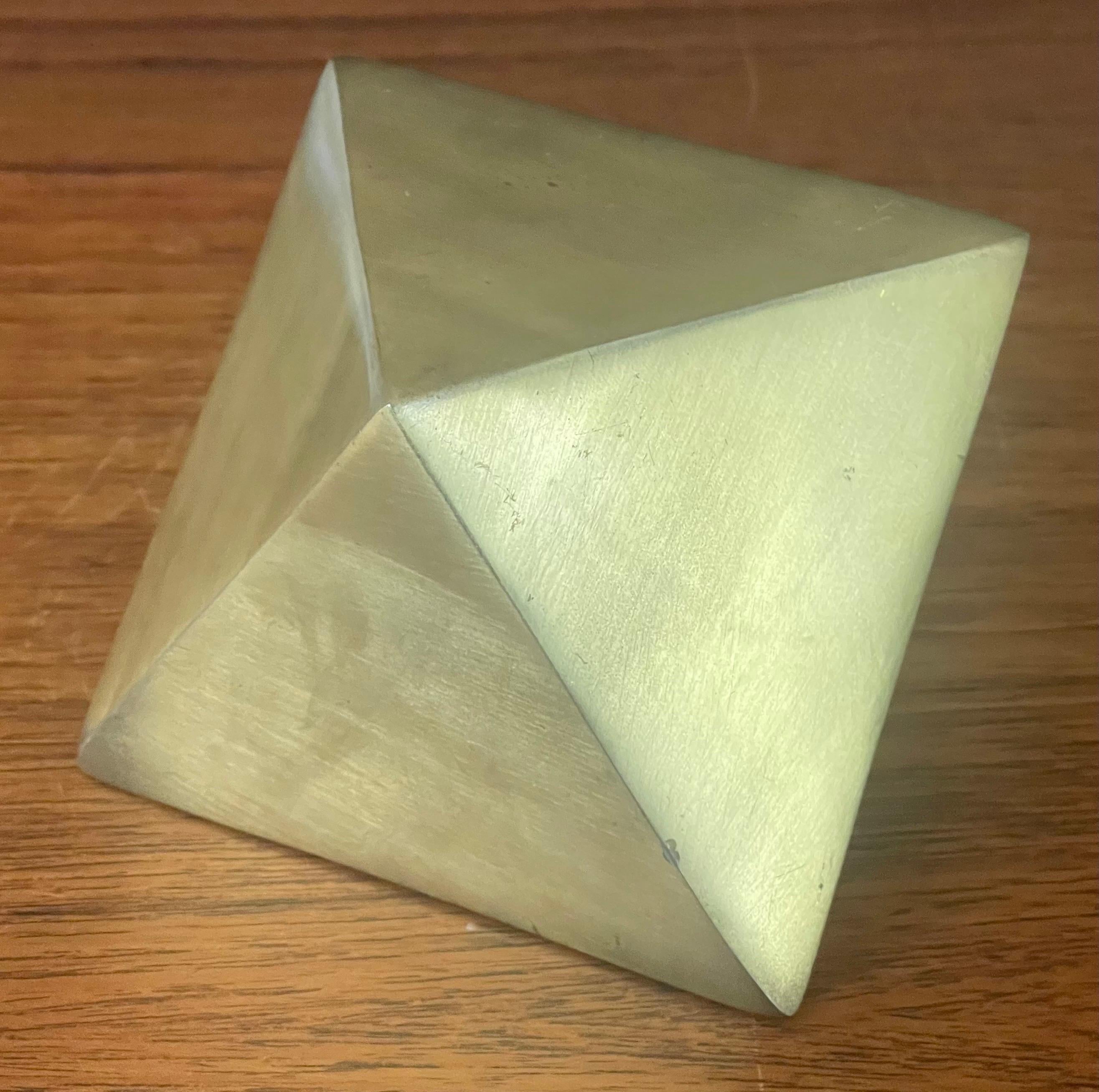 Vintage diamond shaped brass paperweight, circa 1960s. The piece has a well worn brass patina and measures 4.25