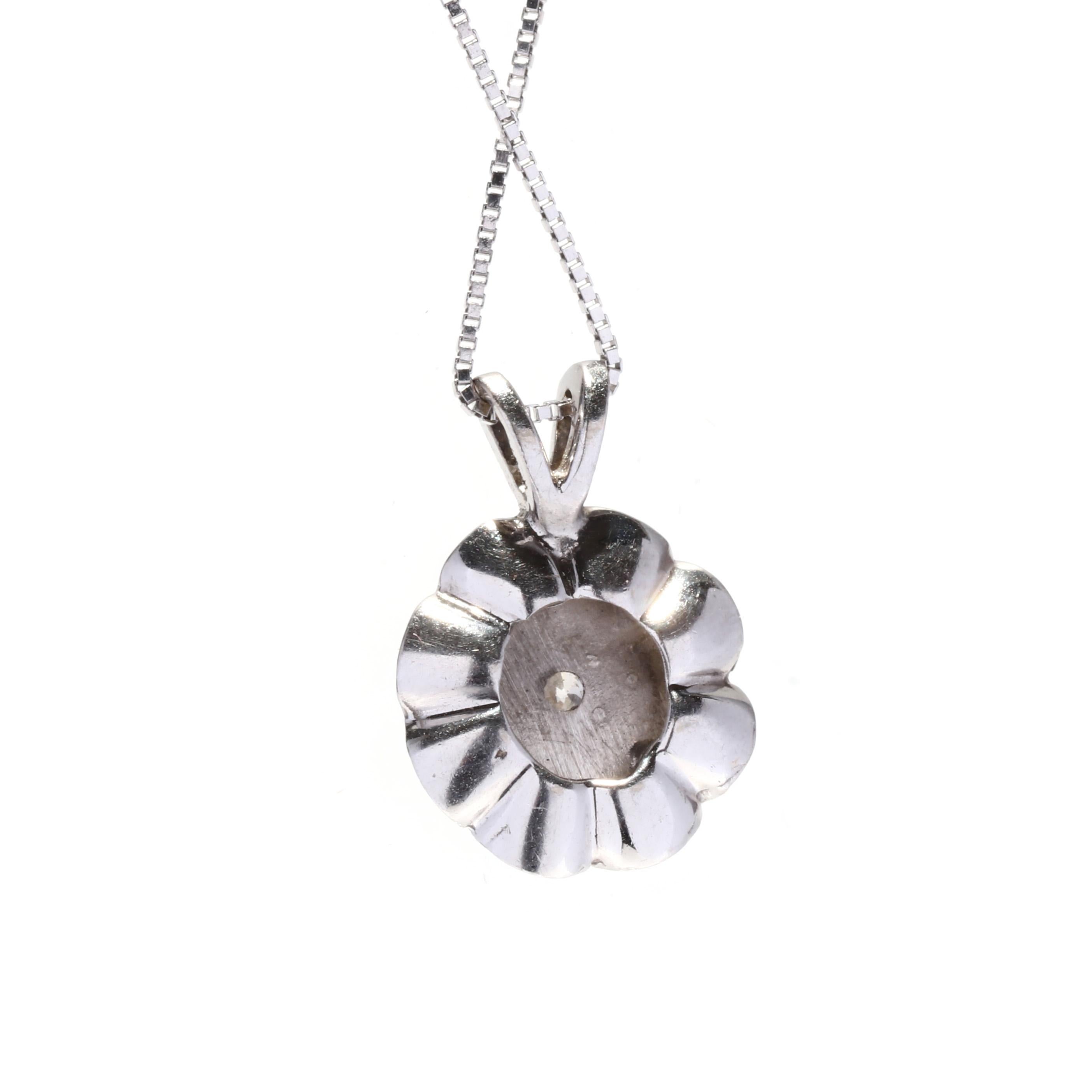 A 14 karat white gold vintage diamond solitaire necklace. This diamond flower necklace features a prong set full cut round diamond weighing approximately .11 carat set in a floral motif pendant suspended from a thin box chain.

Stones:
- diamond, 1