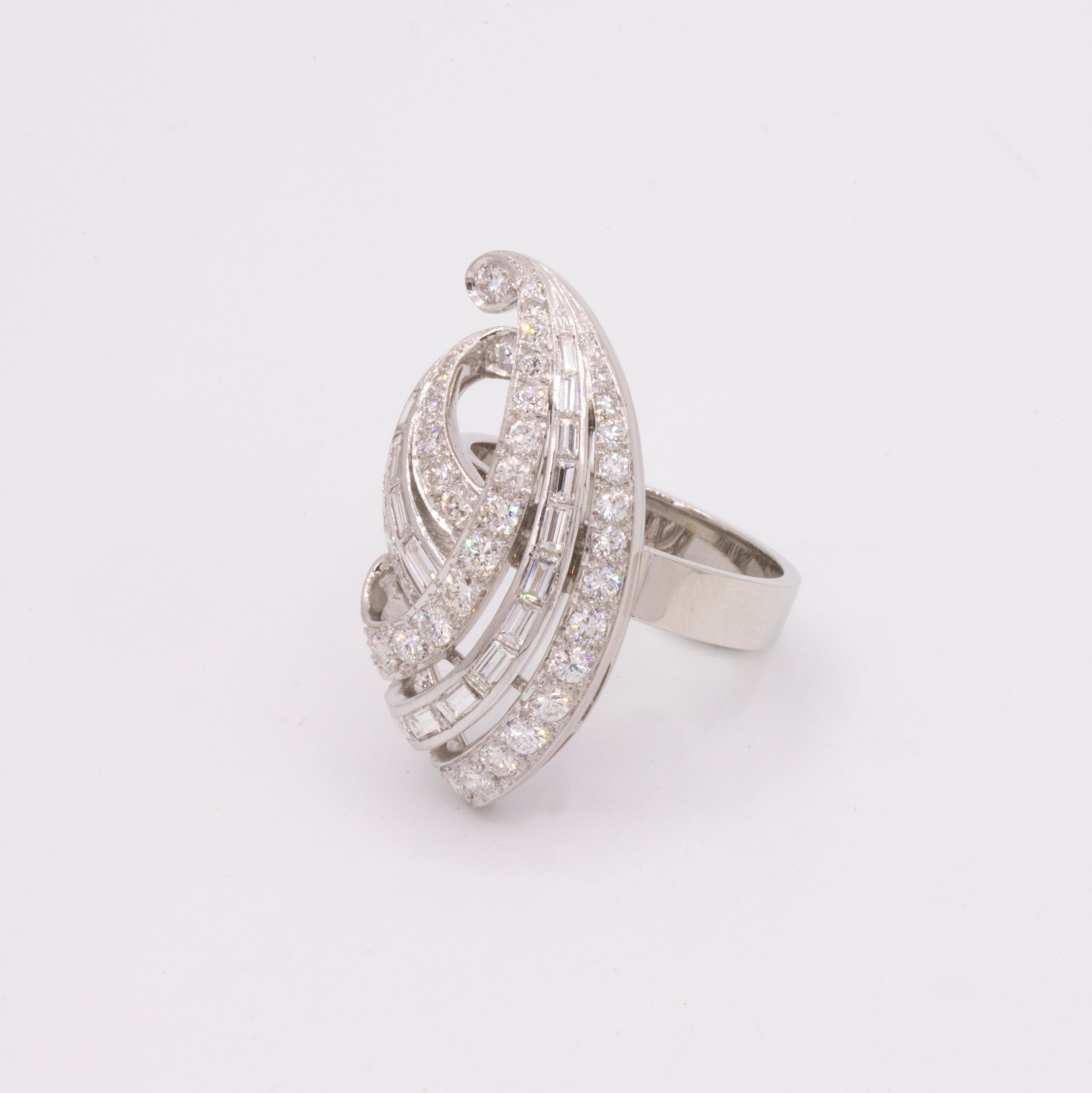Vintage,  Circa 1940s Diamond Swirl Ring. The diamonds are cut in two different styles, Baguette & Round Brilliant. There are 36 Round Brilliant cut diamonds with a total weight of 1.00 carat. There are 15 Baguette diamonds with a total weight of
