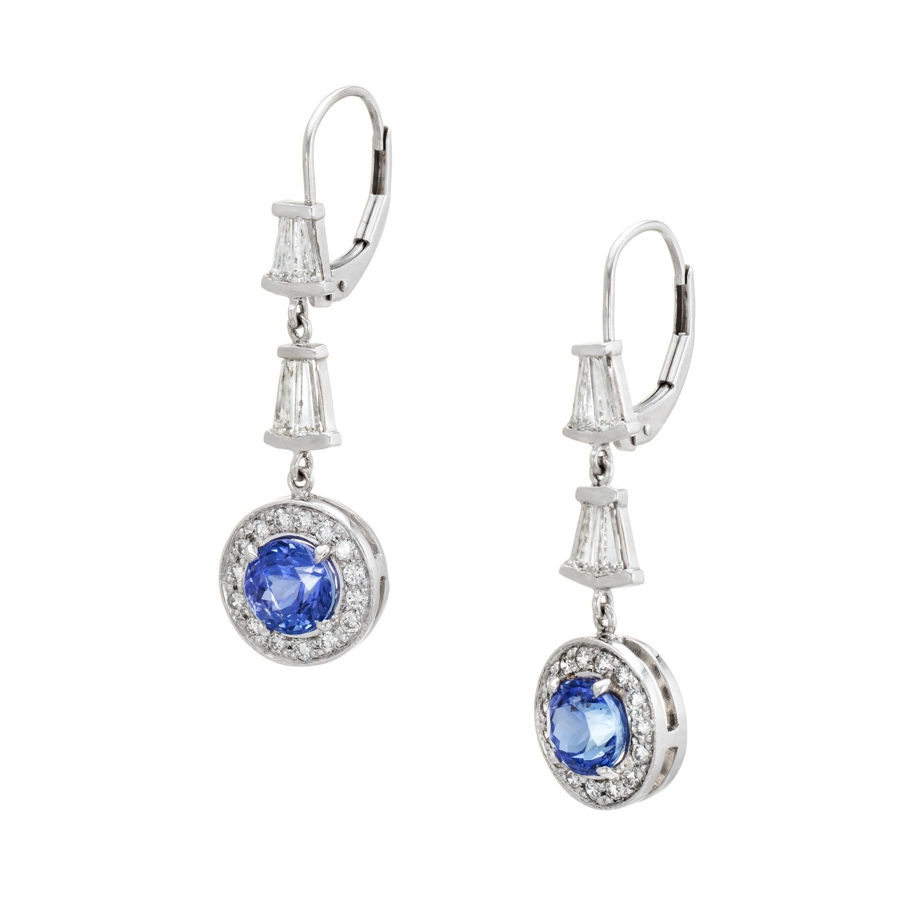 Elegant pair of vintage diamond & tanzanite earrings, crafted in 14k white gold. 

Round brilliant and baguette cut diamonds total an estimated 1.10 carats (estimated at H-I color and SI1-2 clarity). The faceted round cut tanzanite each measures 6mm