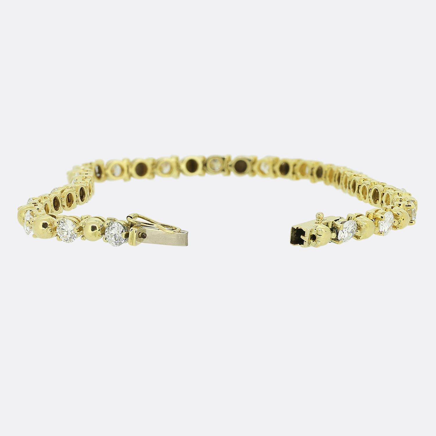 Here we have a cheerful and bright, dazzling diamond tennis bracelet. This elegant piece has been perfectly handcrafted from 18ct yellow gold and showcases an alternating array of polished gold spheres and round brilliant cut diamonds. 

Condition: