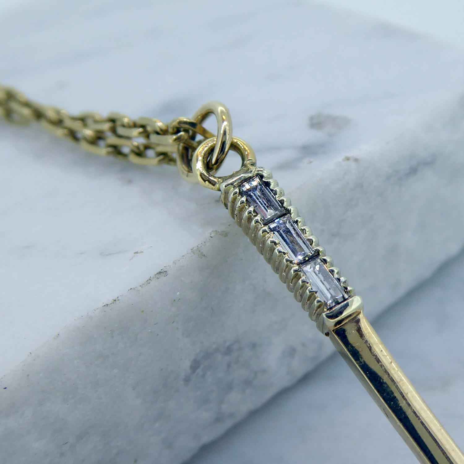 Vintage diamond pendant for the sporting enthusiast. Crafted in 9ct yellow gold in the shape of a tennis racquet and set with 32 round brilliant cut diamonds all around the edge and three baguette cut diamonds are set into the handle.  The combined