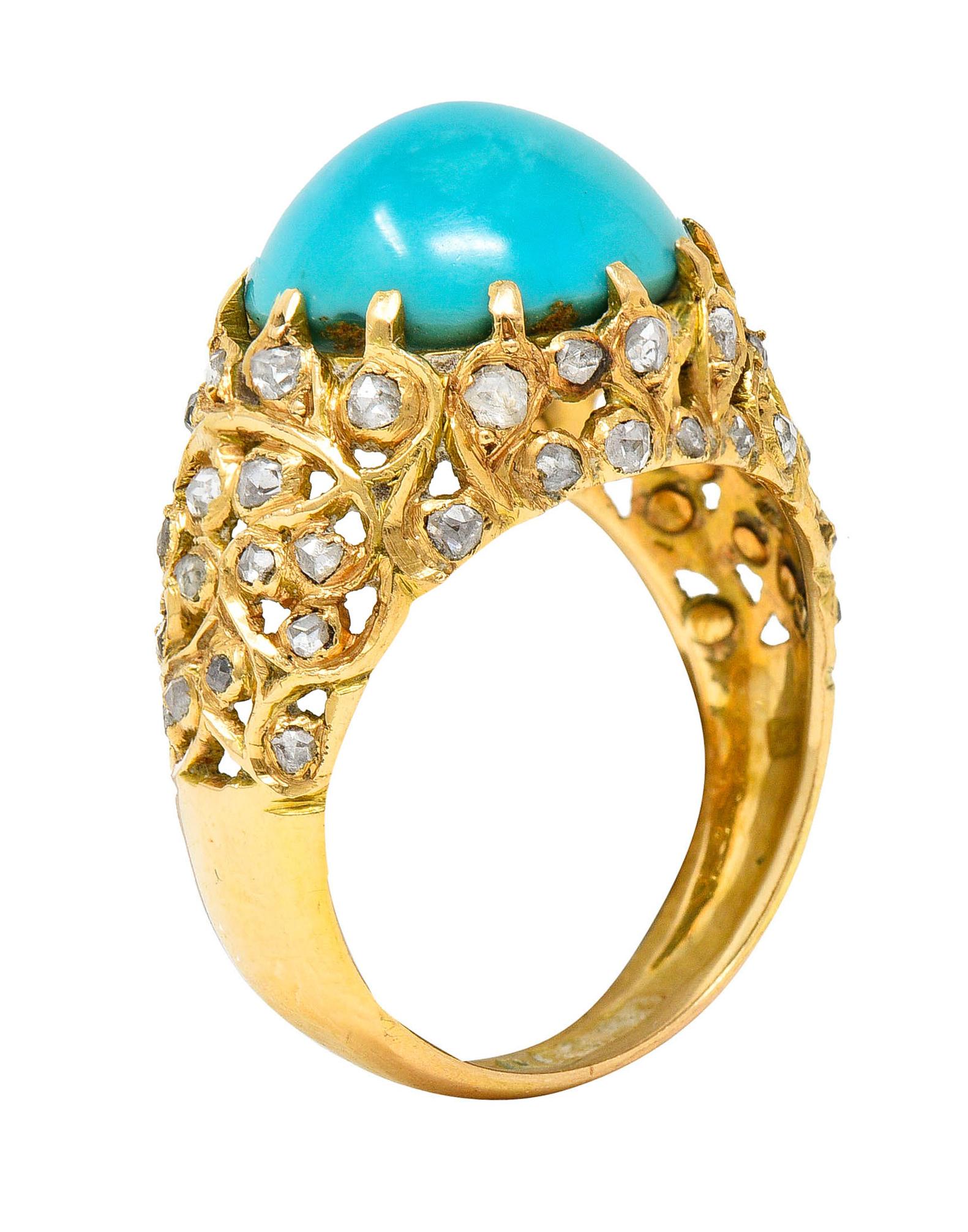 Bombè band ring features a 12.5 mm round turquoise cabochon

Opaque with slightly greenish and strongly blue color with moderately swirled color distribution

Talon set then surrounded by pierced and scrolling foliate motifs

Accented throughout by
