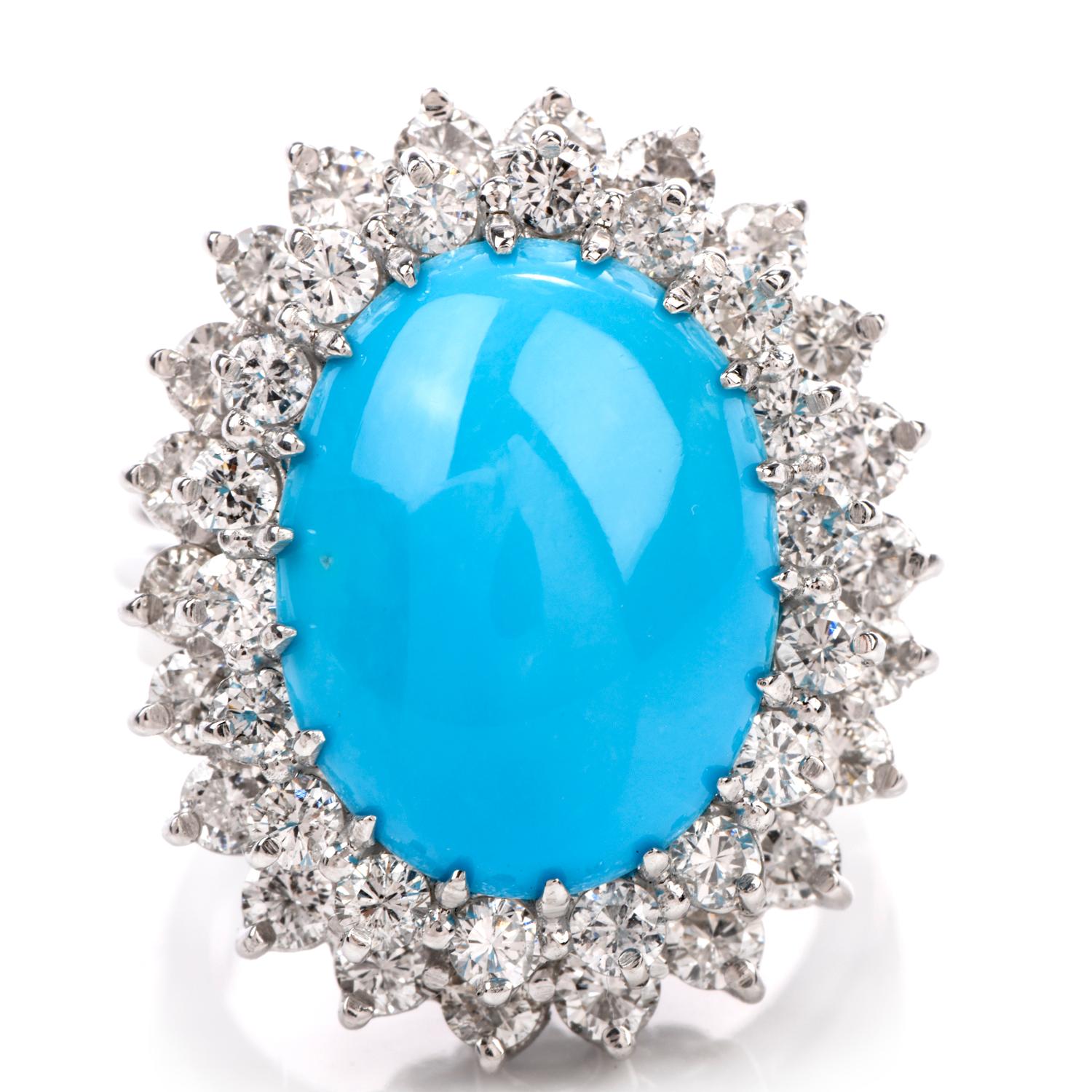This Diamond and Oval Turquoise Statement Ring was inspired in a Double Halo  and crafted in 9.0 grams of 18k white gold. Centered is an oval cabochon Turquoise measuring

approximately 15.8 x 12.3mm; weighing approx. 6.93 carats and is surrounded