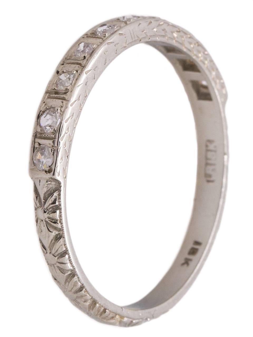 Vintage 18K white gold diamond wedding band containing ten bright and lively bead set single cut diamonds with a combined weigh of approxmiatley 0.20ct, SI2-I1/H-I (near colorless). Lovely hand engraved wheat pattern with romantic floral design.